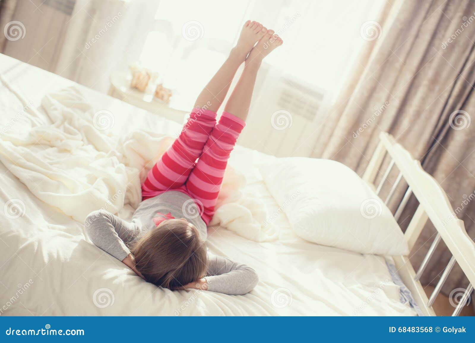Child Doing Exercises while Lying in Bed Stock Photo - Image of blanket,  caucasian: 68483568