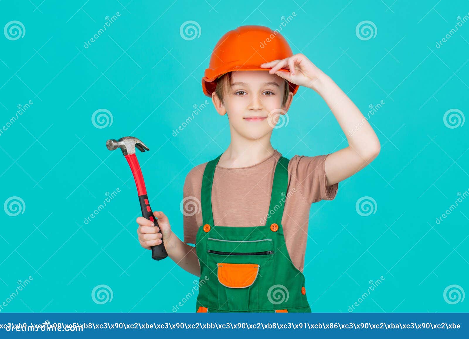 child dressed as a workman builder. little boy wearing helmet. portrait little builder in hardhats hammer. child