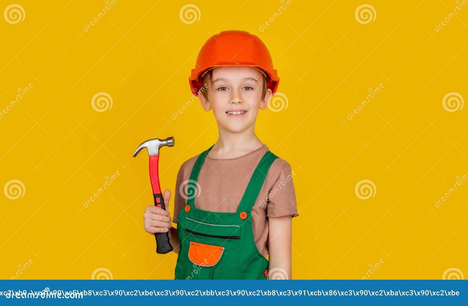 child dressed as a workman builder. little boy wearing helmet. portrait little builder in hardhats hammer. child