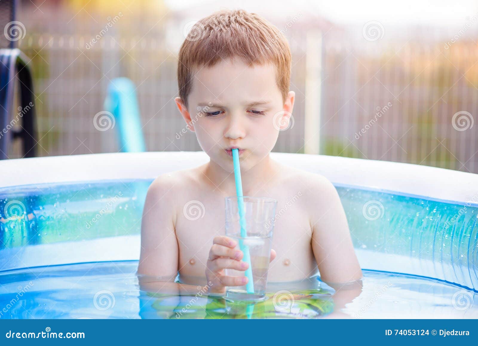 Child Drinking Lemonade in Inflatable Garden Pool Stock Photo - Image