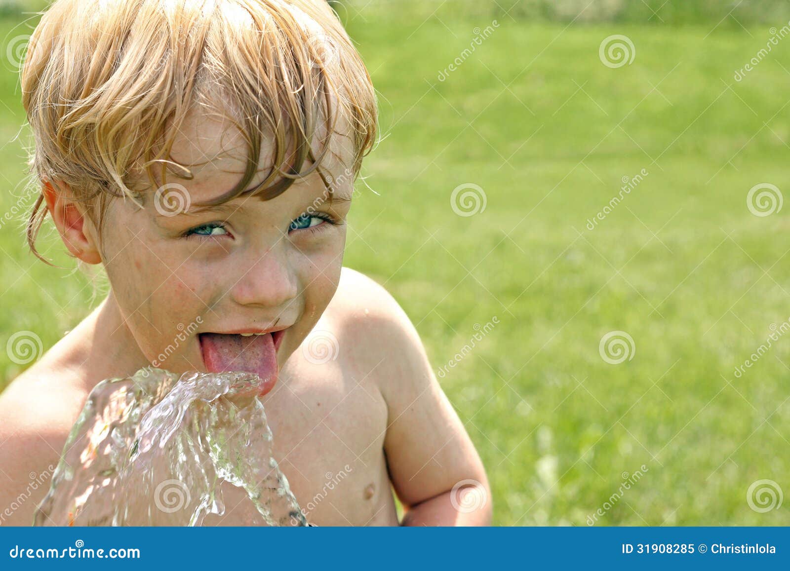 child drinking water from hose