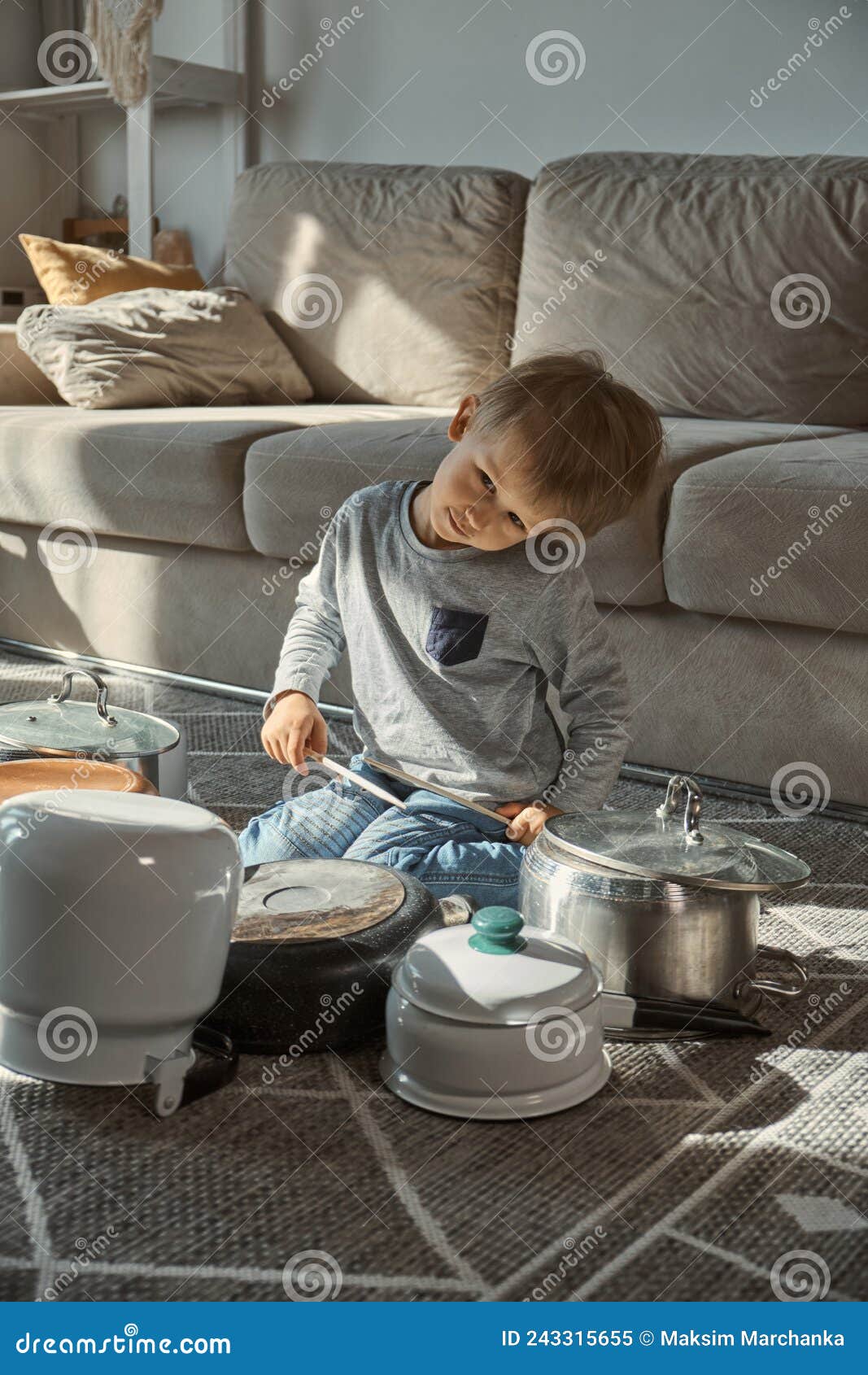 Child Drummer Having Fun Drum Playing on Kitchen Pans at Home Stock