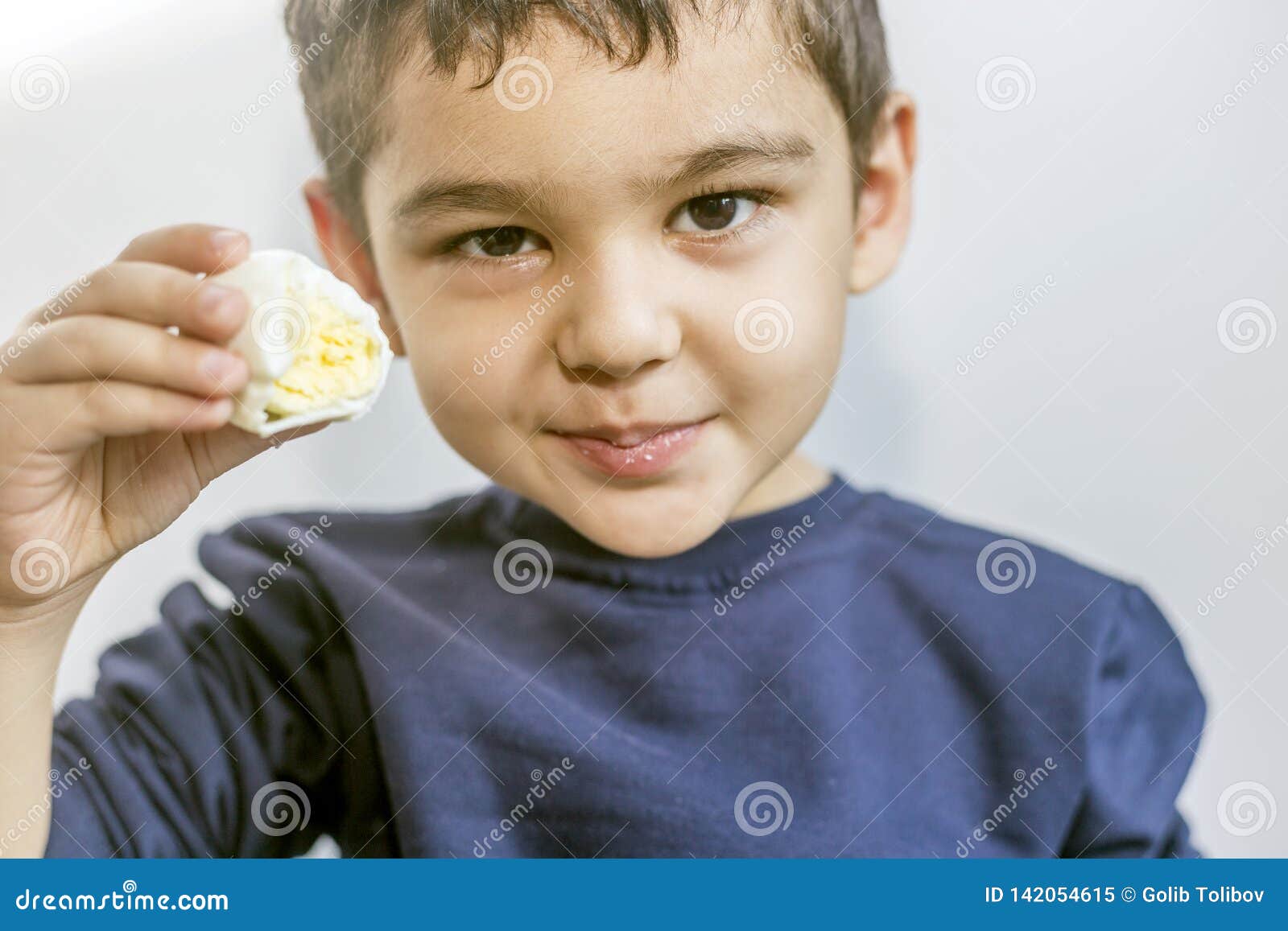 Boy Eating Boiled Corn On Beach Royalty Free Stock Photography boy-eating-boiled-corn-on-beach-royalty-free-stock-photography