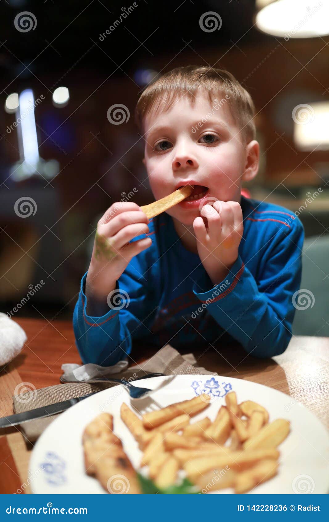 Child Eating Fried Potatoes Stock Photo Image of dinner, french