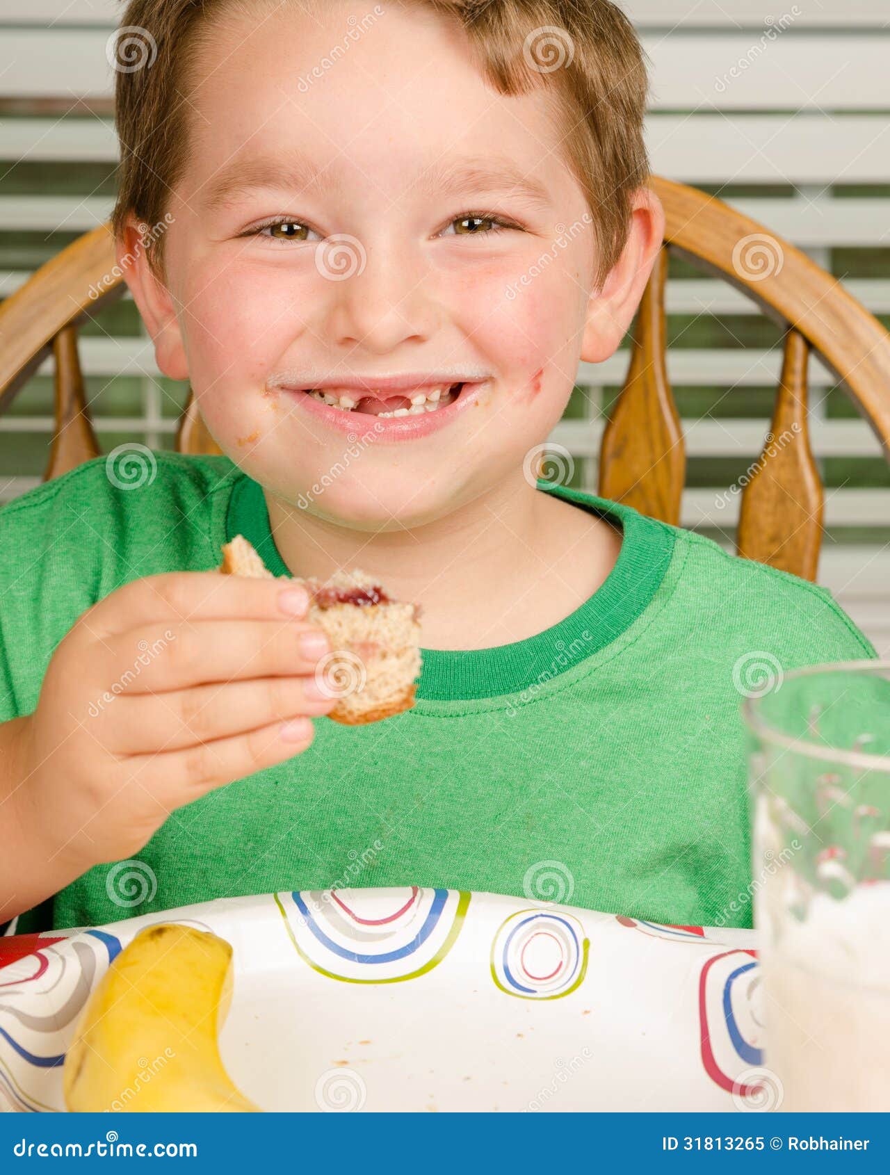Child Eating Messy Peanut Butter And Jelly Sandwich Stock Image