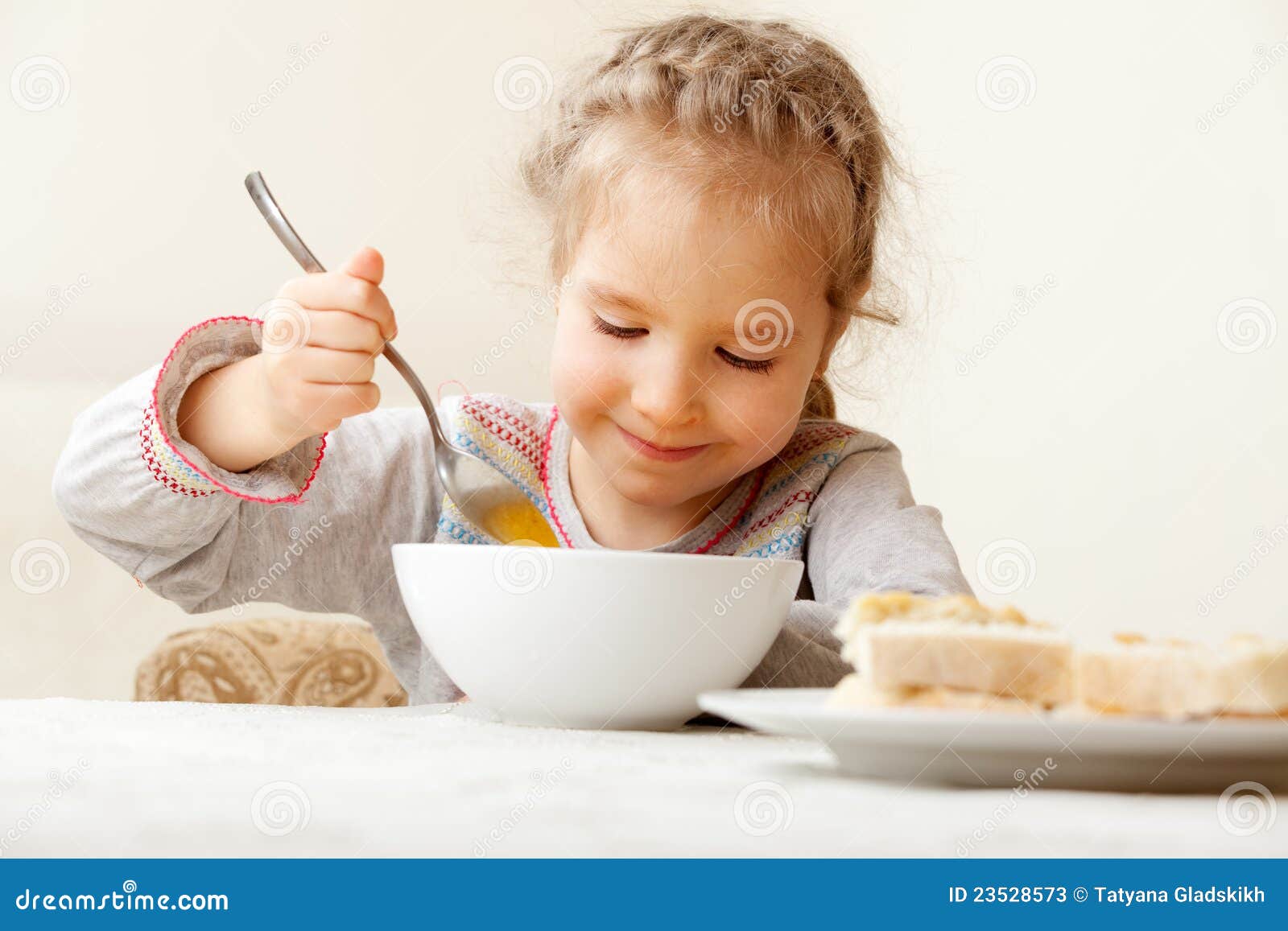 Child eating soup at home stock image. Image of bread 23528573