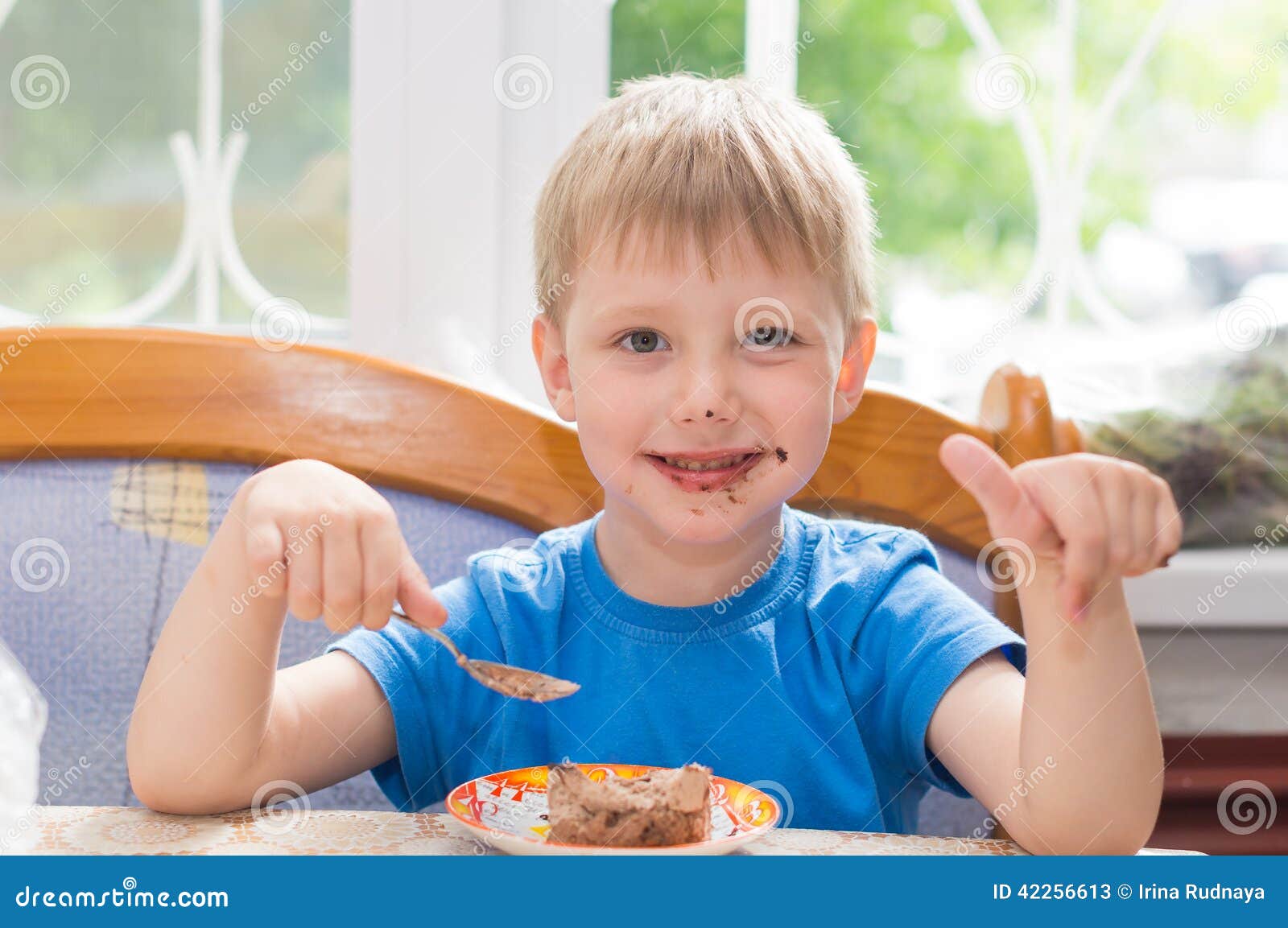 The child eats a dessert stock image. Image of table 42256613