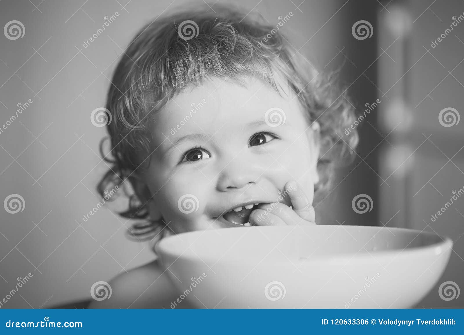 Child Eats Porridge. Portrait of Little Baby Boy Eating Stock Photo ...