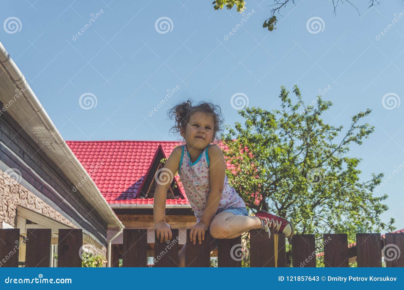 Girl Climbs The Fence On A Summer Day Stock Image Image Of Looking