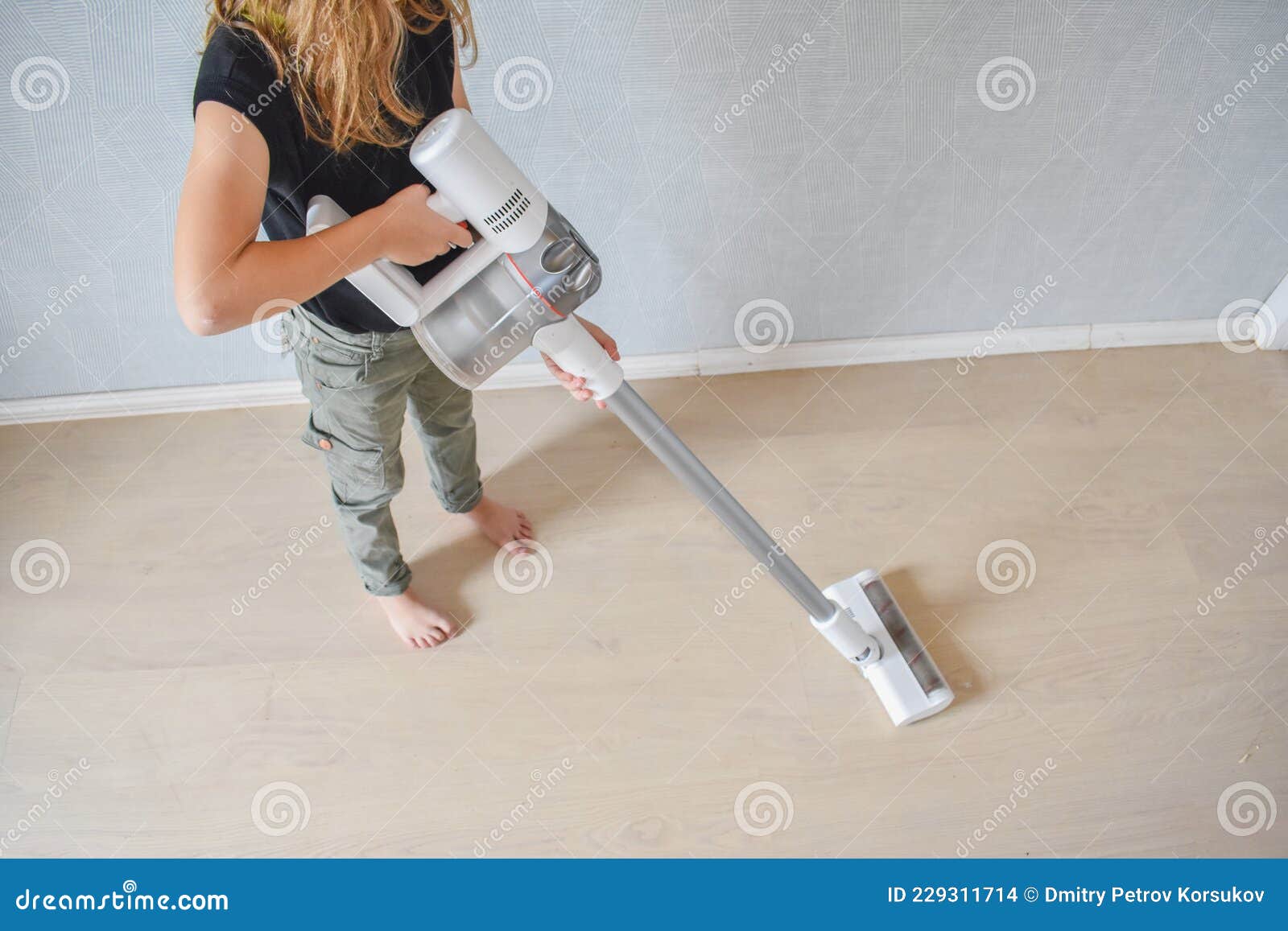 Child Girl Does Vacuuming in the House Photo without Processing Stock