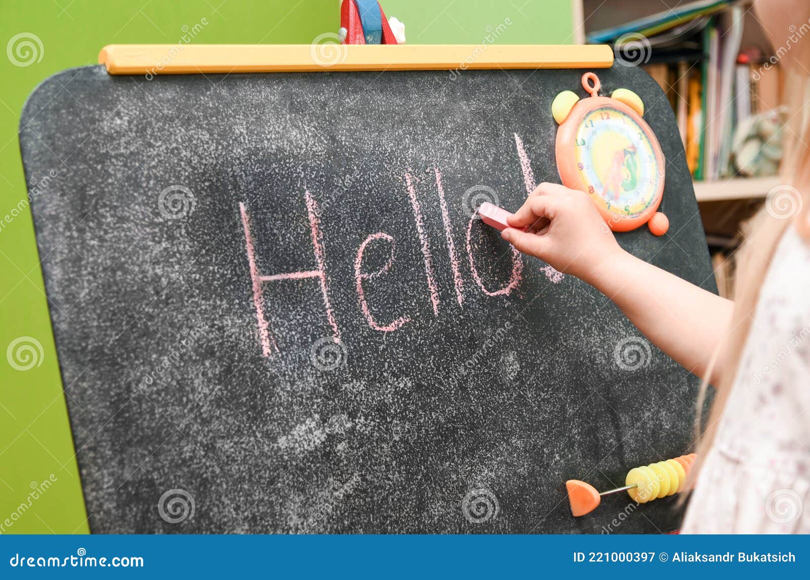 Child Girl Learning To Write on Drawing Board at Home Stock Image