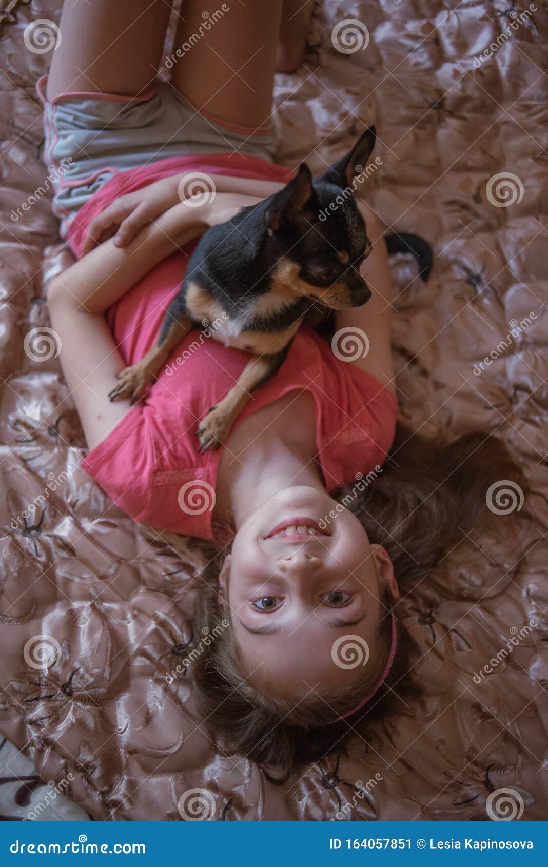 Child Girl Plays With Little Dog