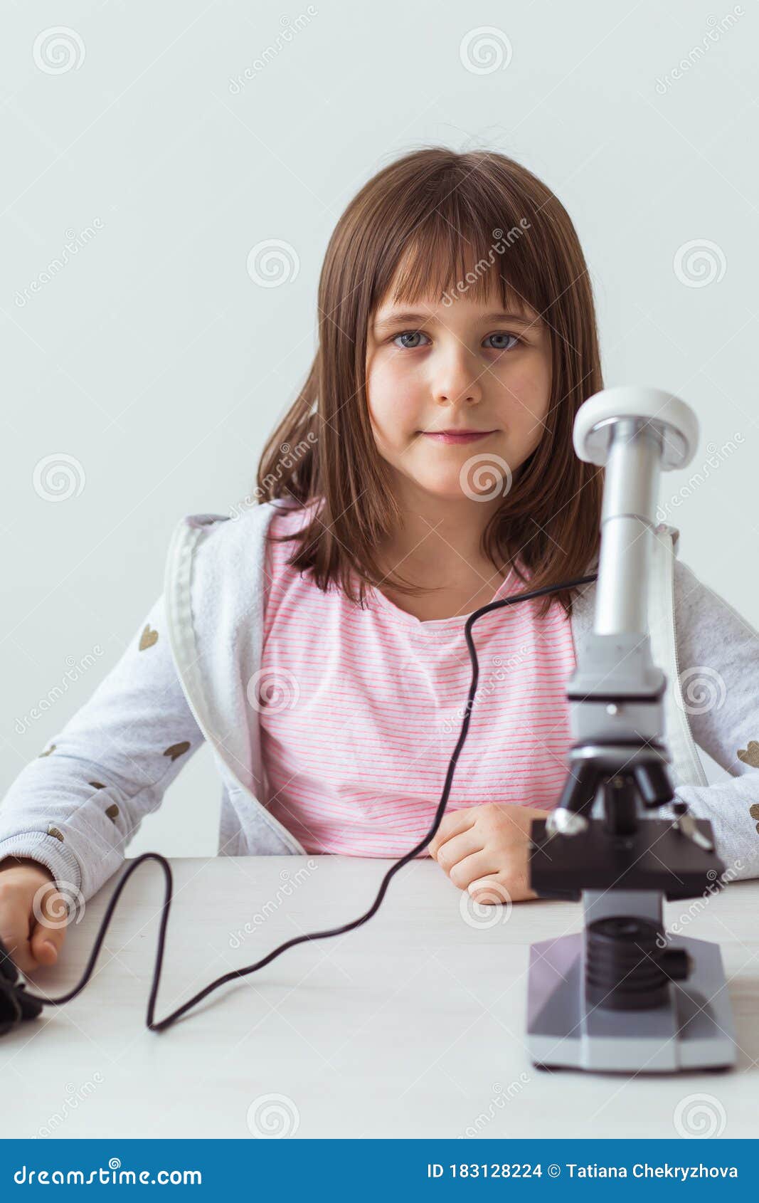 Child Girl in Science Class Using Digital Microscope. Technologies