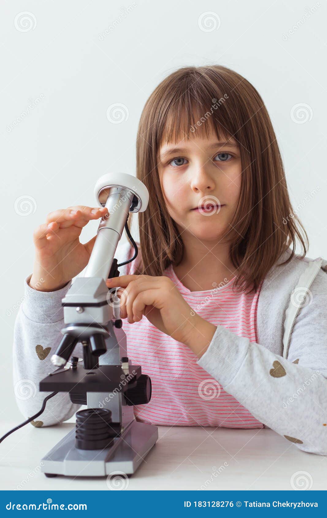 Child Girl in Science Class Using Digital Microscope. Technologies