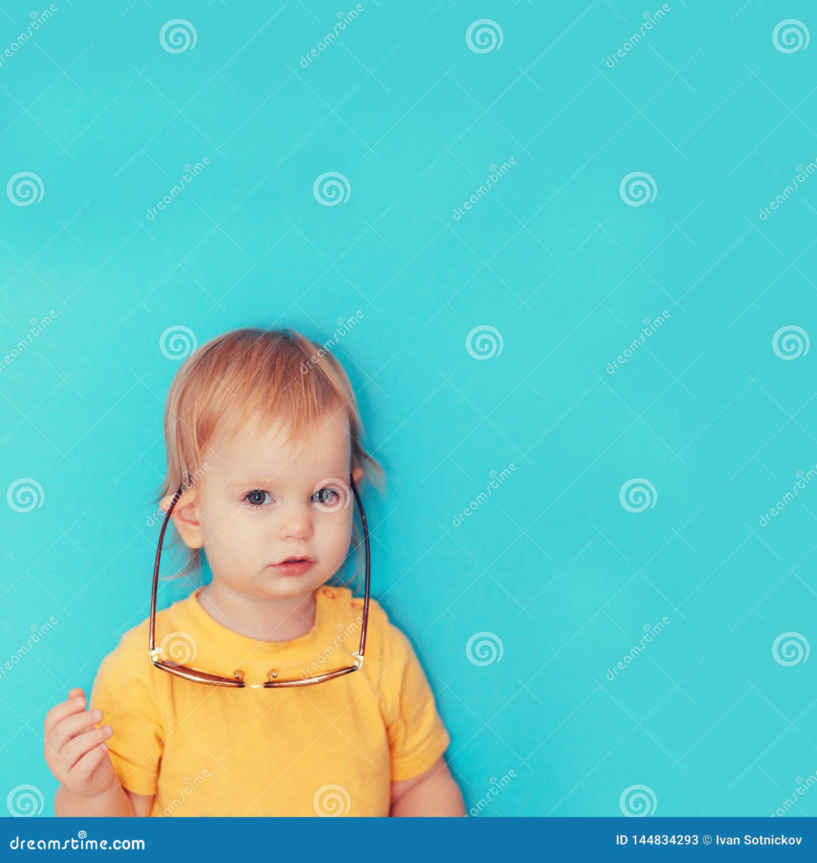 child with glasses hanging on his ears