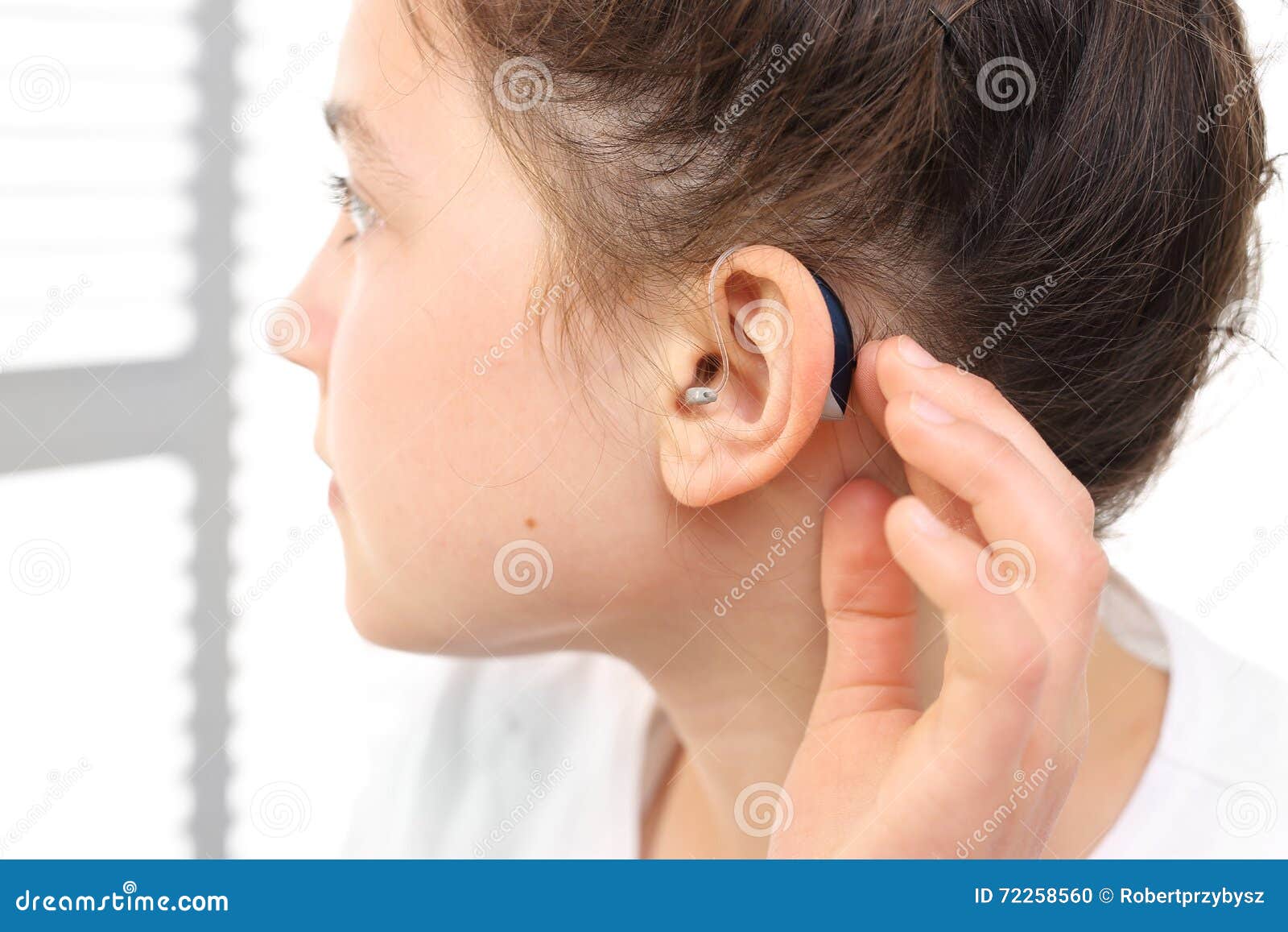 A child with a hearing aid stock photo. Image of earmold 72258560