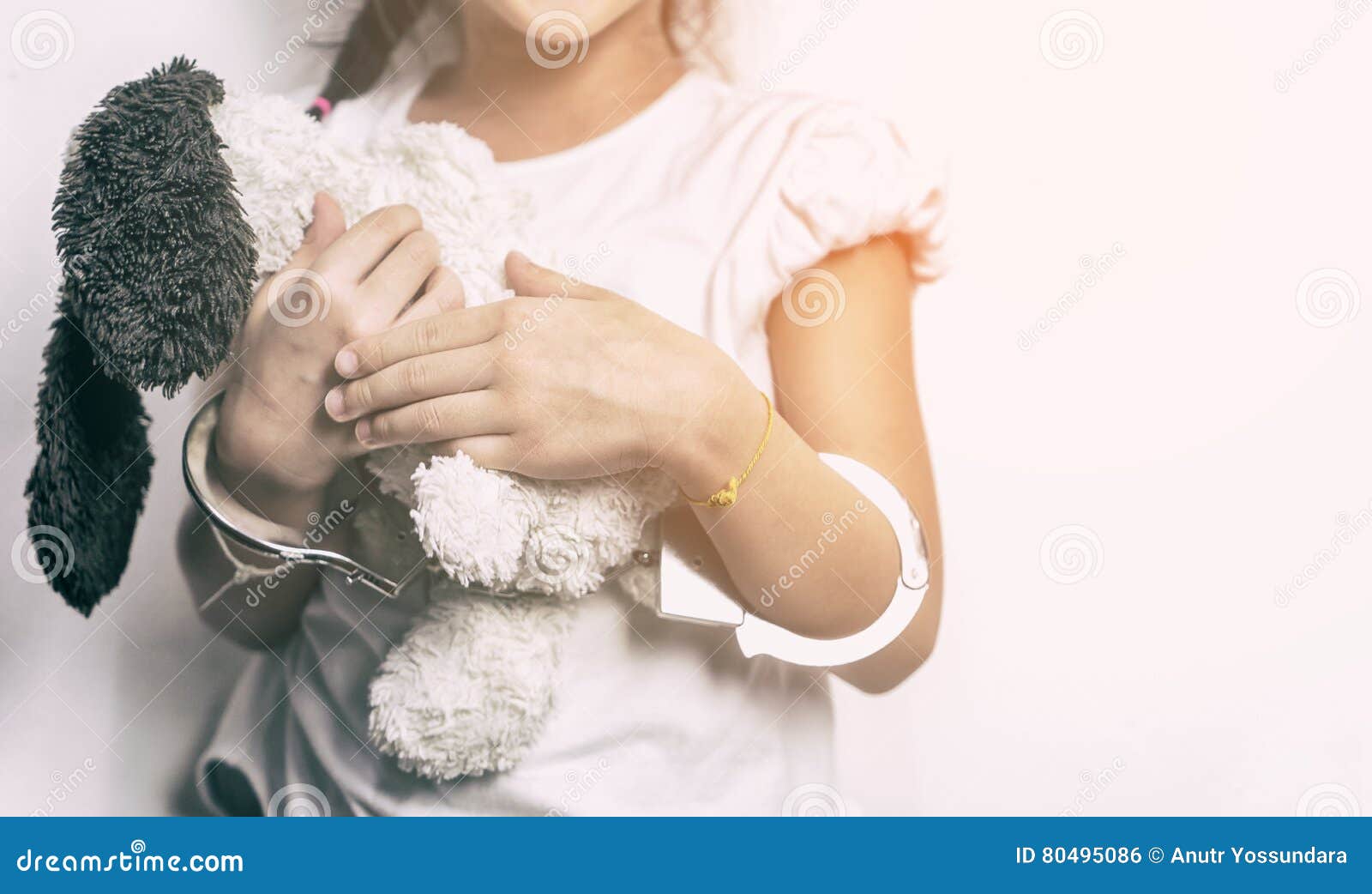 Child Holding a Doll with Her Hand in Handcuffed Stock Photo Image of