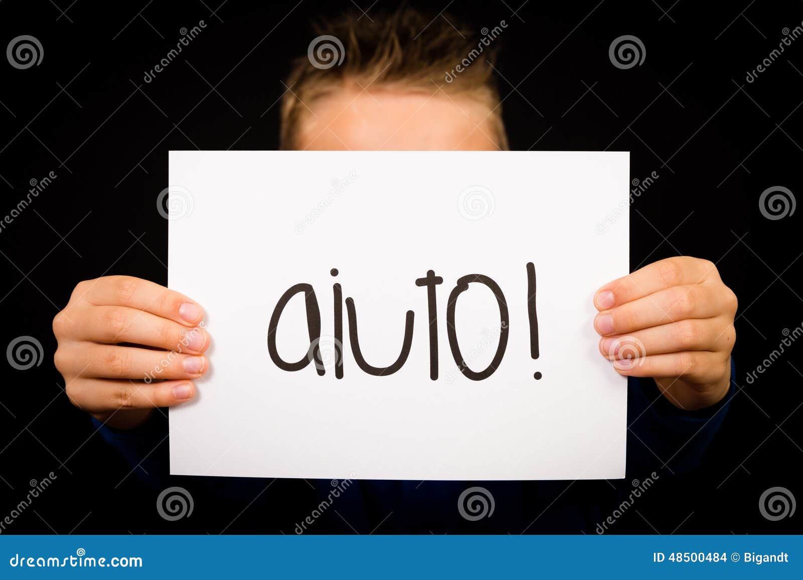 child holding sign with italian word aiuto - help
