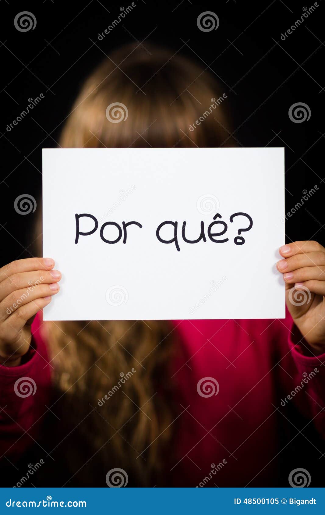 child holding sign with portuguese word por que - why