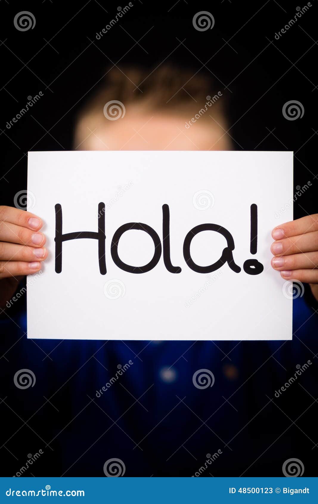 child holding sign with spanish word hola - hello