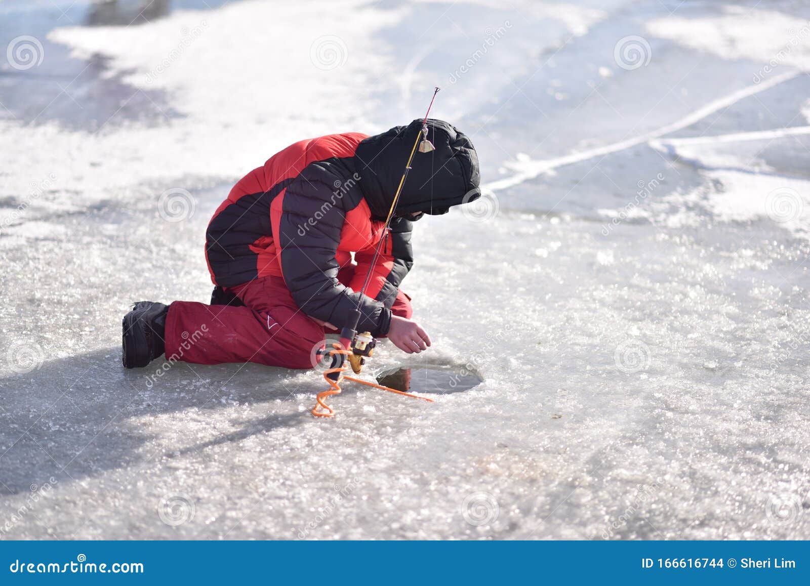 Boy Ice Fishing on Lake in Winter on a Sunny Day with Reflection in Water  Stock Photo - Image of beautiful, polennn: 166616744
