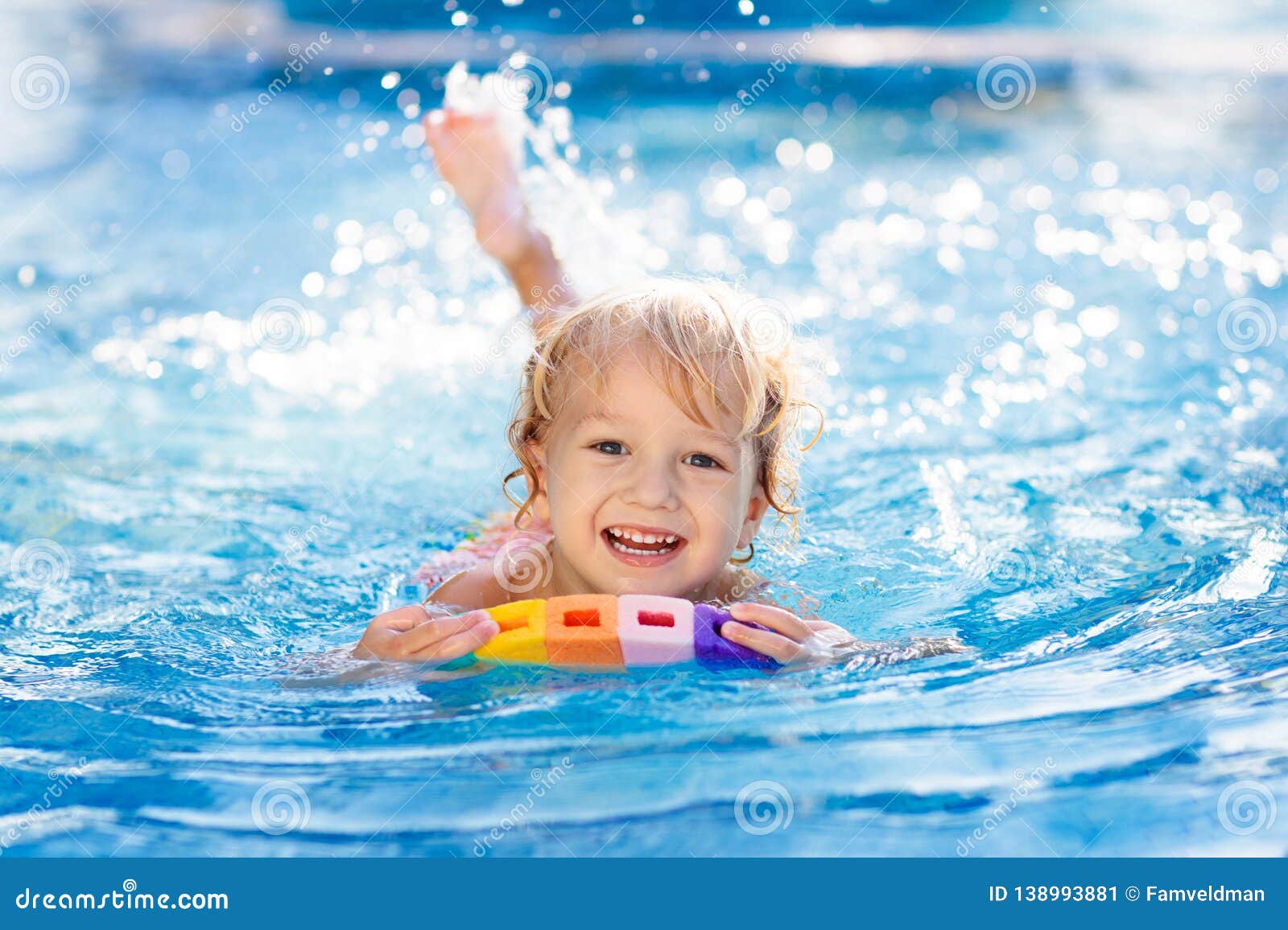 child learning to swim. kids in swimming pool