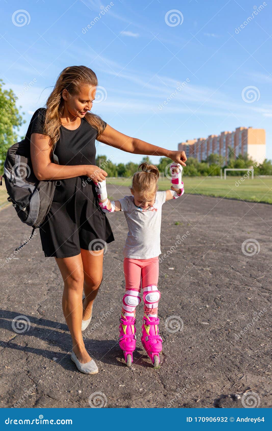 Child Learns To Roller Skate. Roller Skating Stock Photo Image of