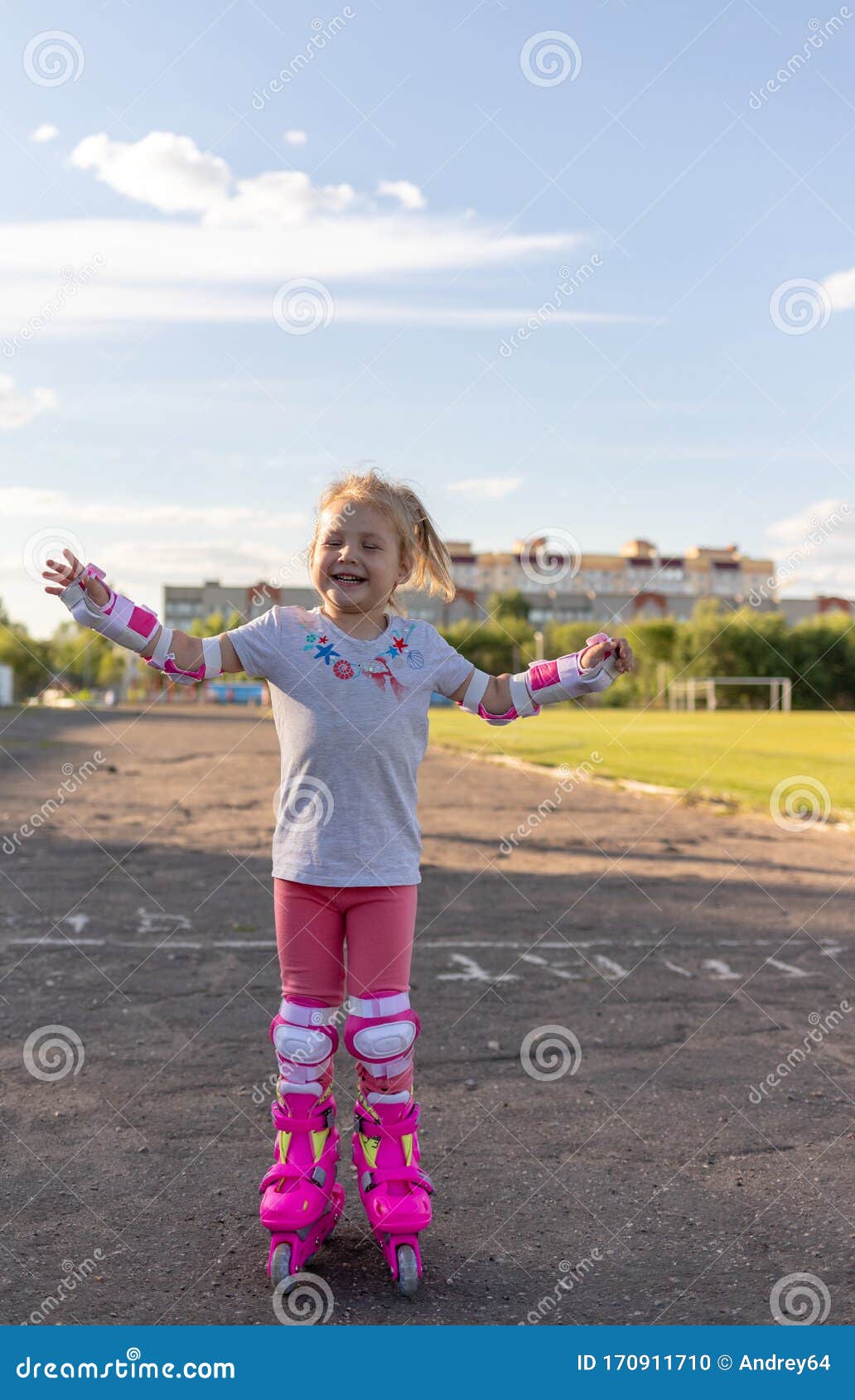 Child Learns To Roller Skate. Roller Skating Stock Photo Image of