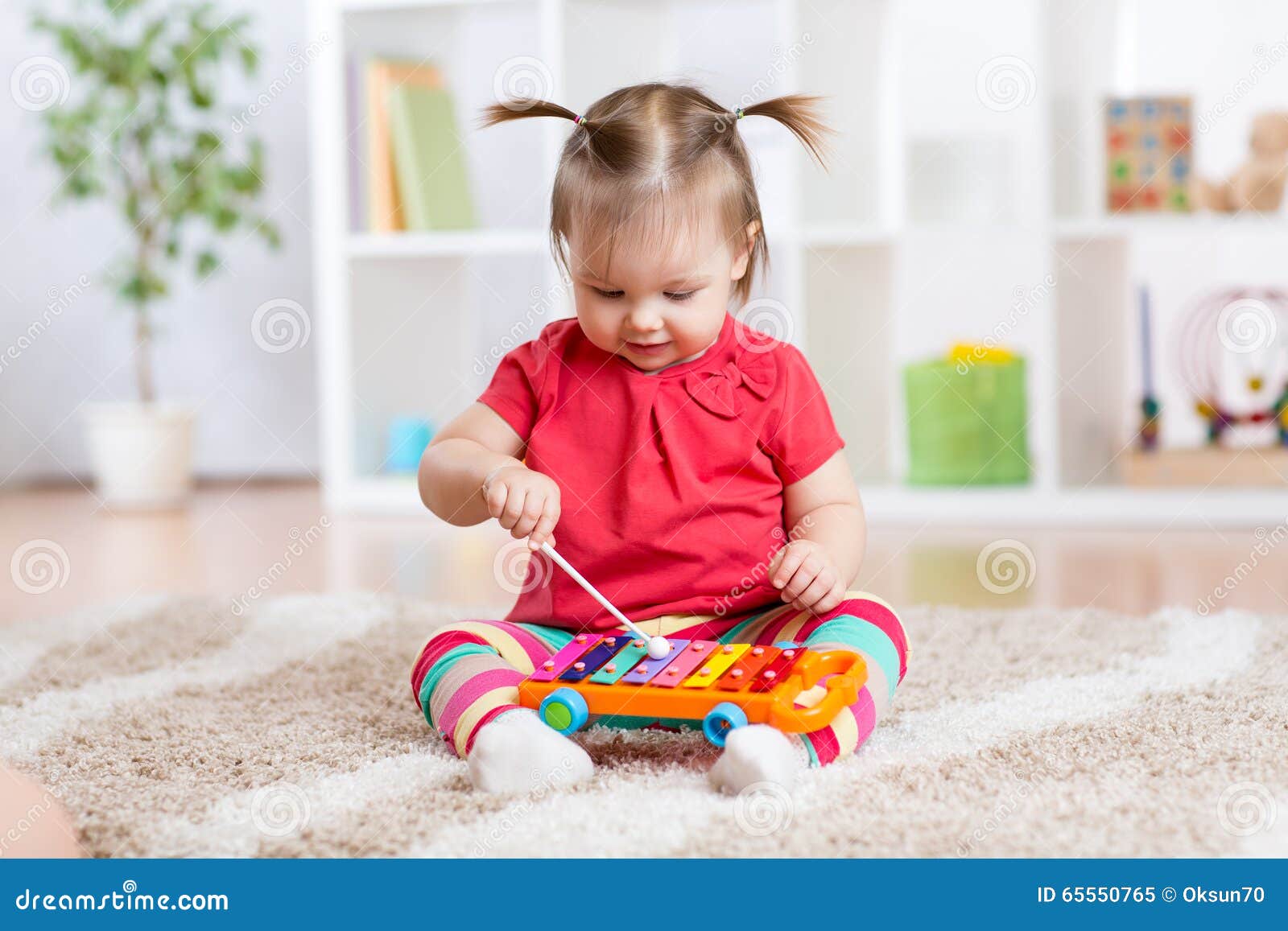 child little girl plays a musical instrument