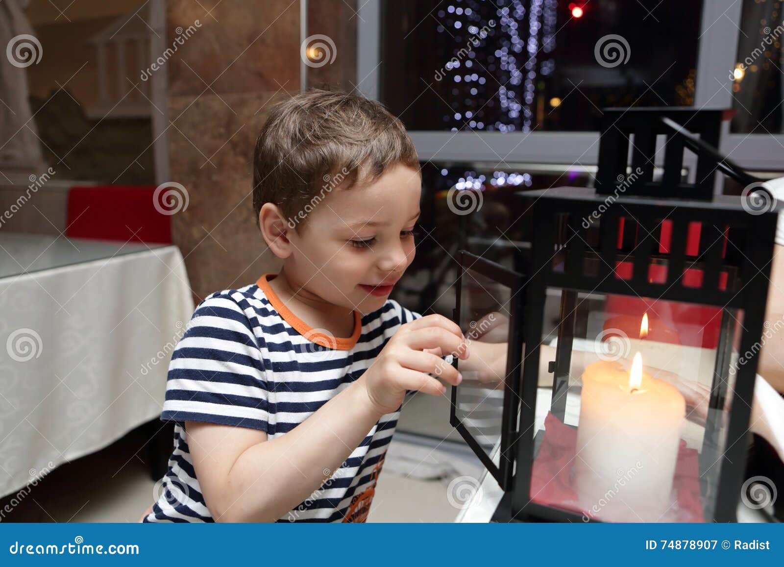 Child looking at candle stock image. Image of flame, celebration 74878907