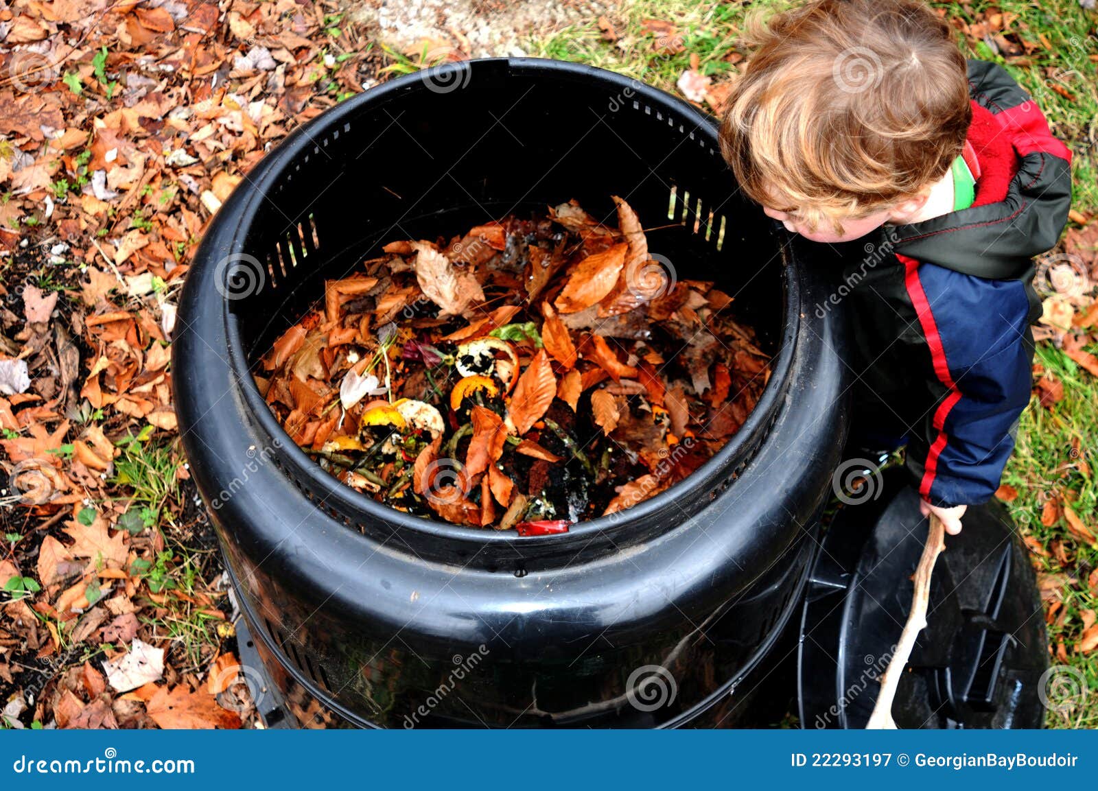 child looking in compost bin