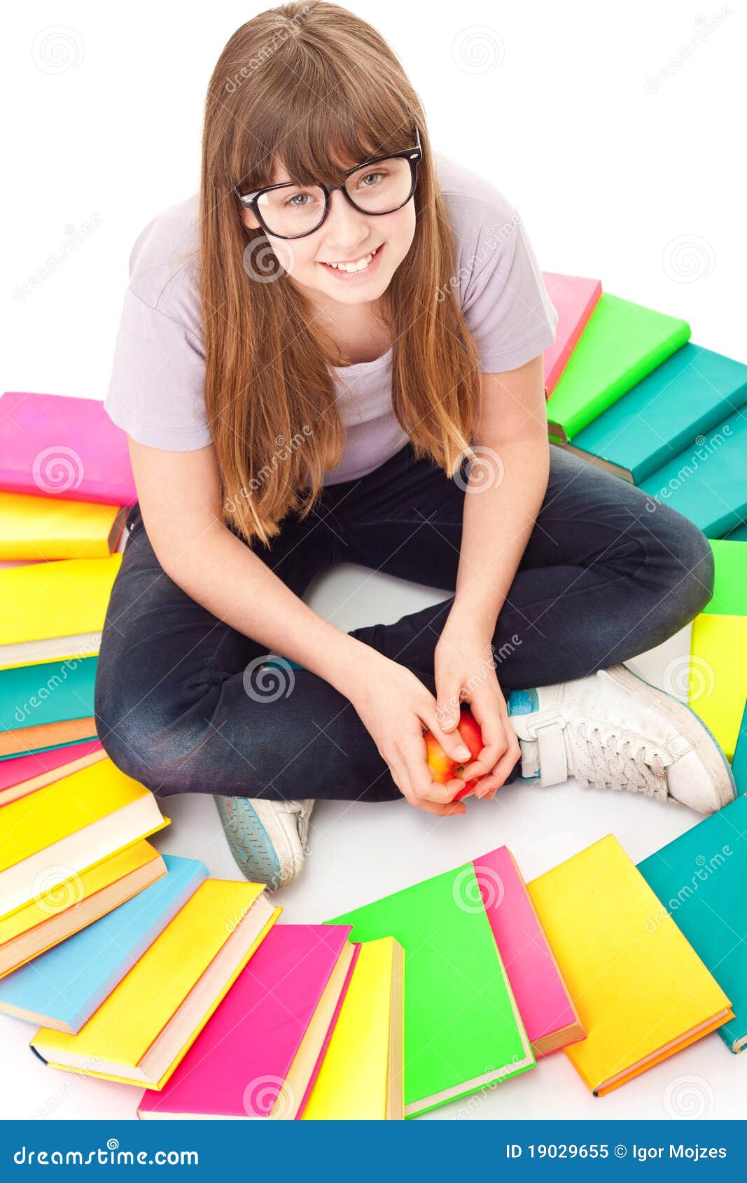 child with lot of books siting on floor