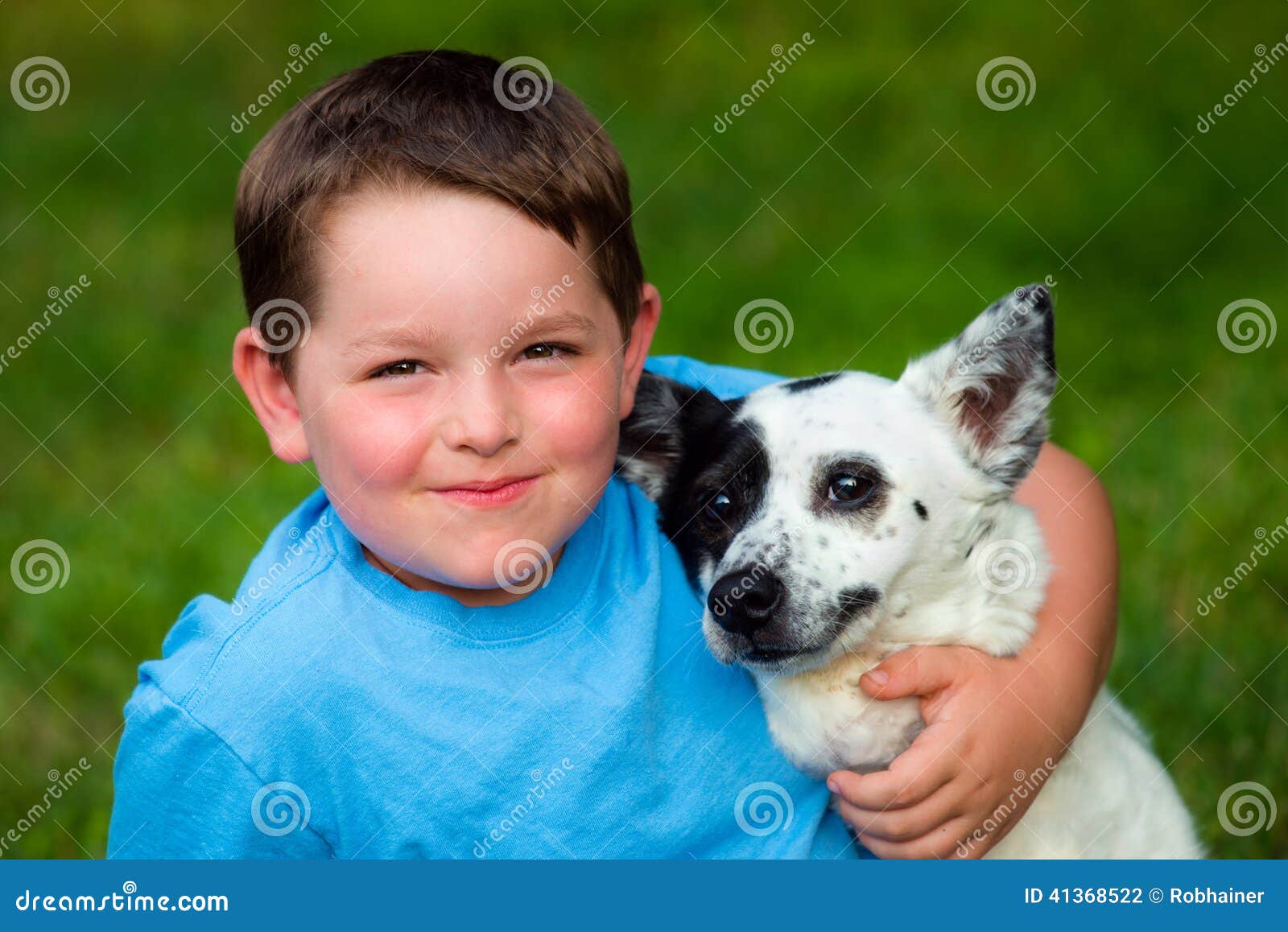 child lovingly embraces his pet
