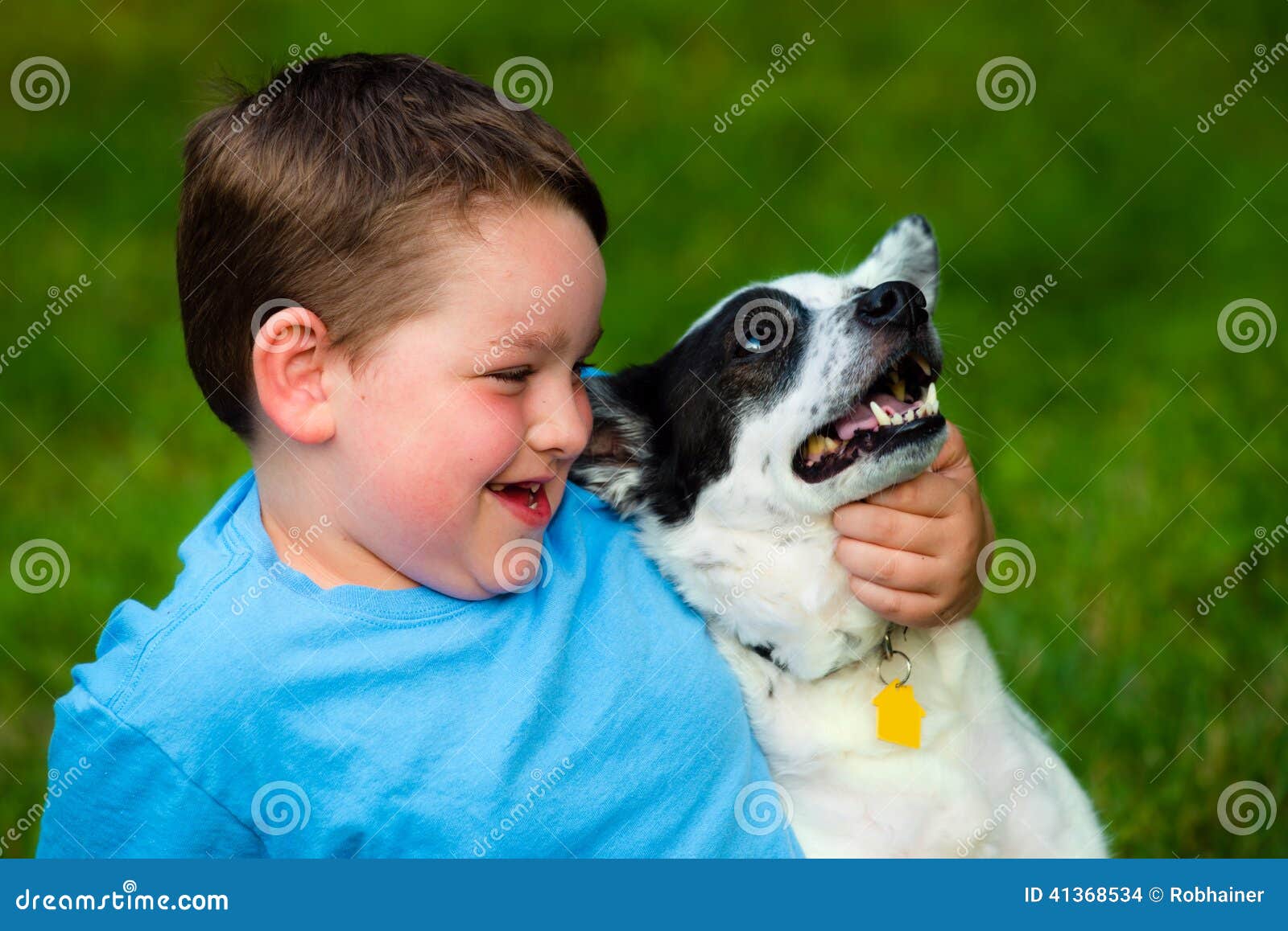 child lovingly embraces his pet