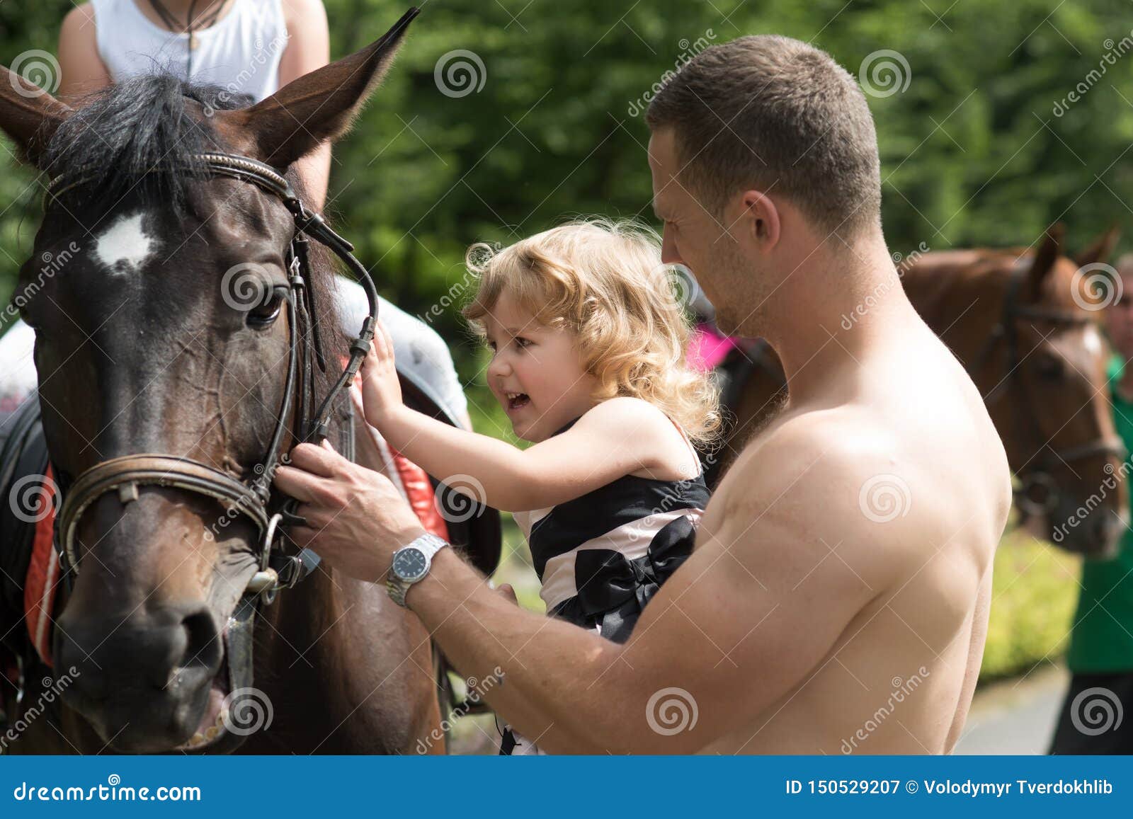 child with muscular macho smile to animal