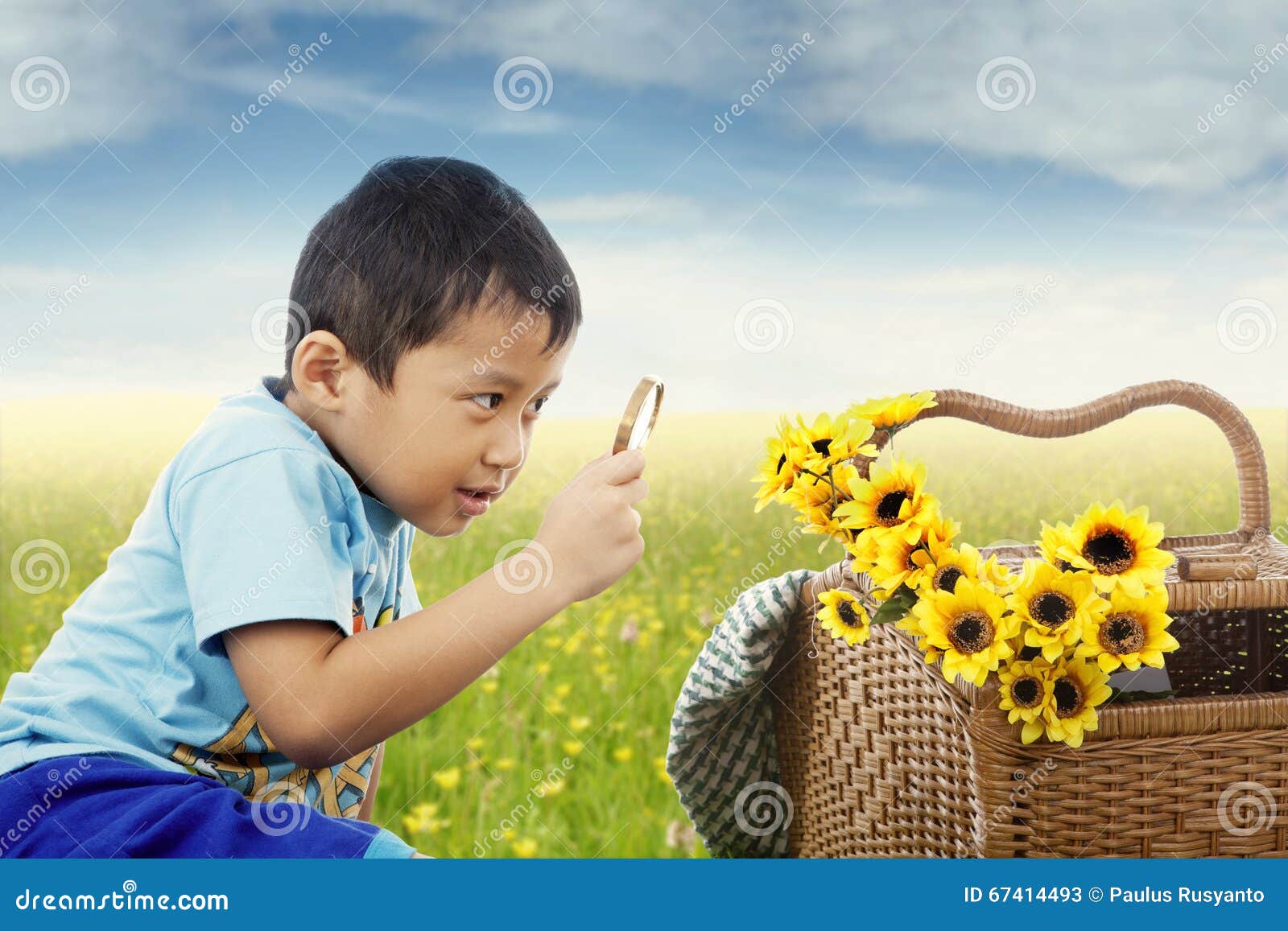 child observe flowers with magnifying glass