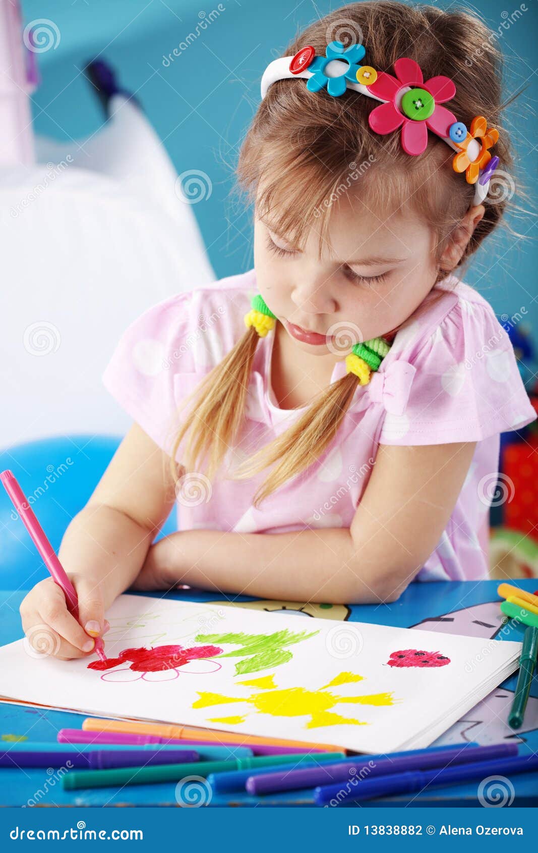 Child painting in her nursery at home