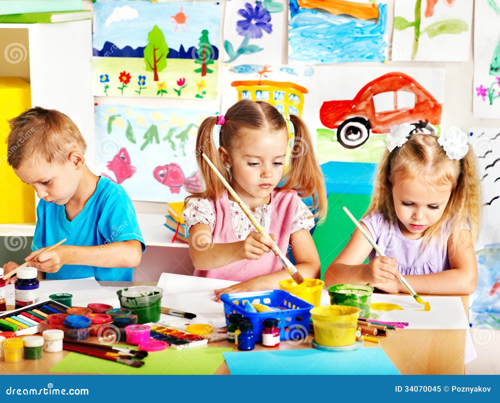 Child painting at easel. stock image. Image of group - 34070045