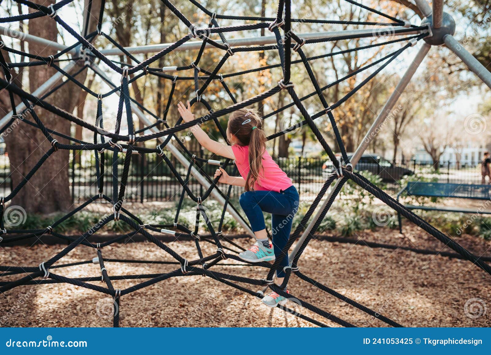 Child at Playground. Little Girl on a Playground Climbing Net