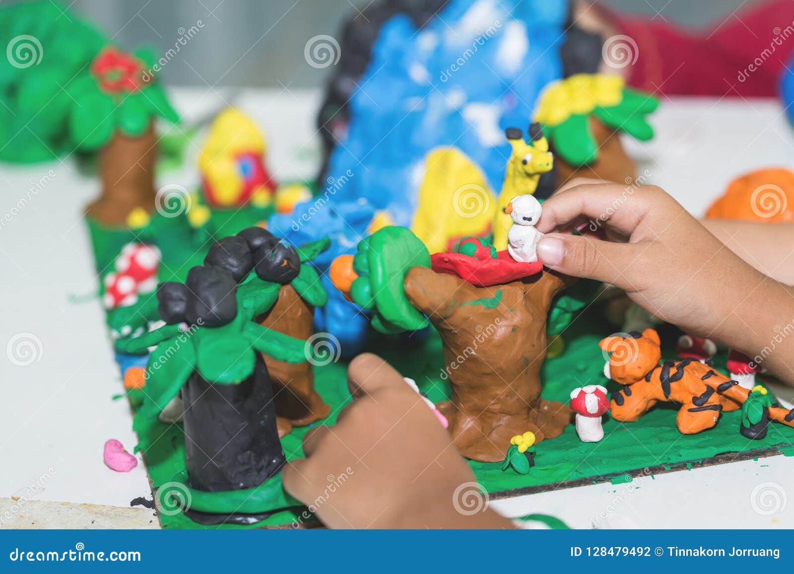 Child Playing With Clay Molding Shapes Stock Photo, Picture and Royalty  Free Image. Image 94228238.