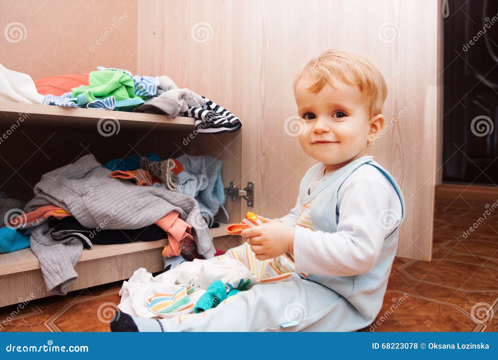 Child playing with clothes stock photo. Image of small 68223078