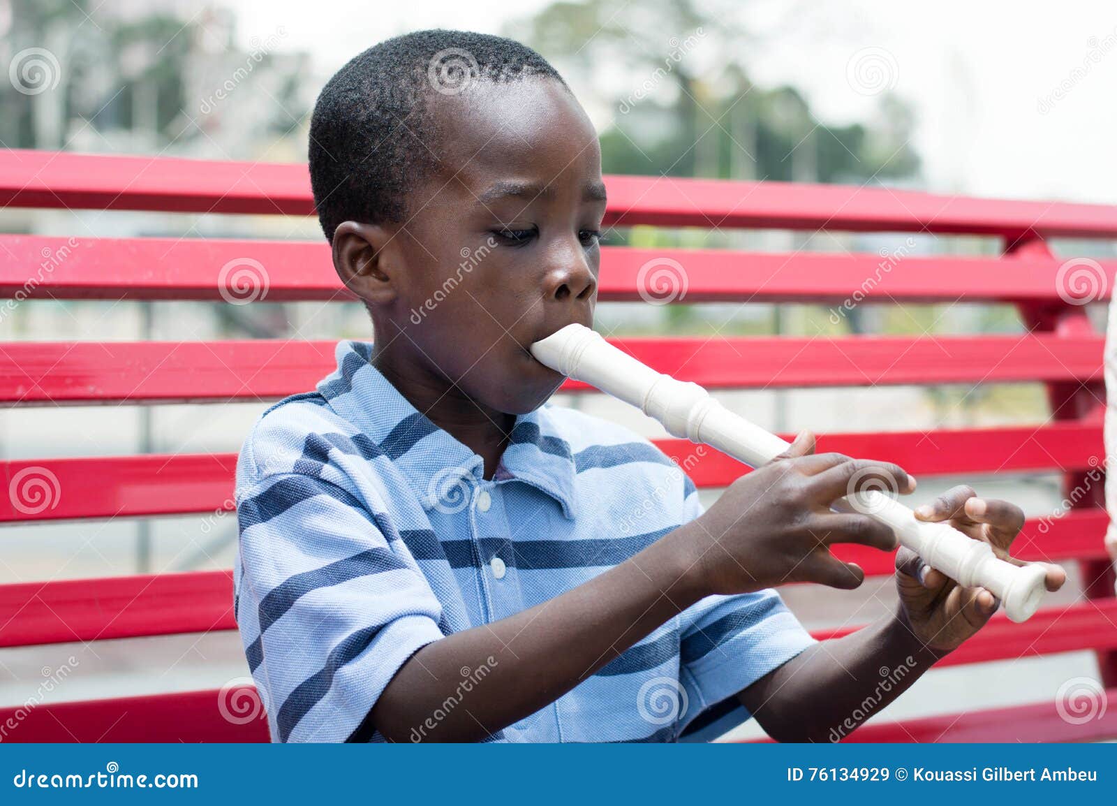 Child playing the flute. stock image. Image of curiosity 76134929