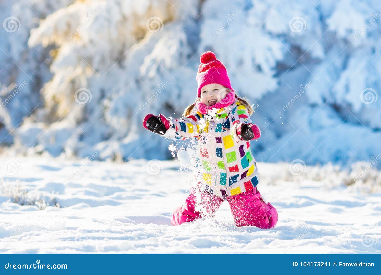 child playing with snow in winter. kids outdoors.