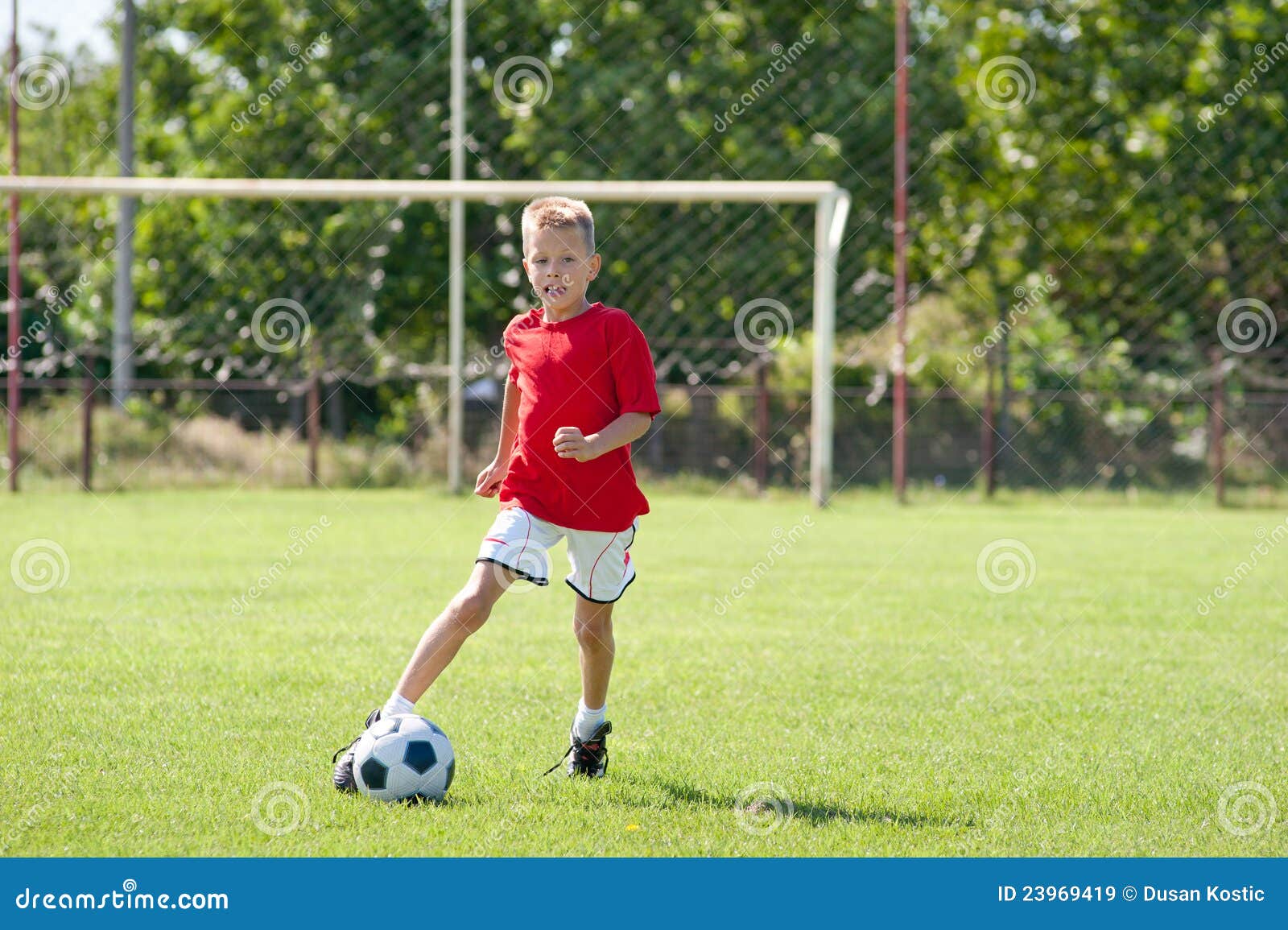Child playing soccer ball stock image. Image of boys 23969419
