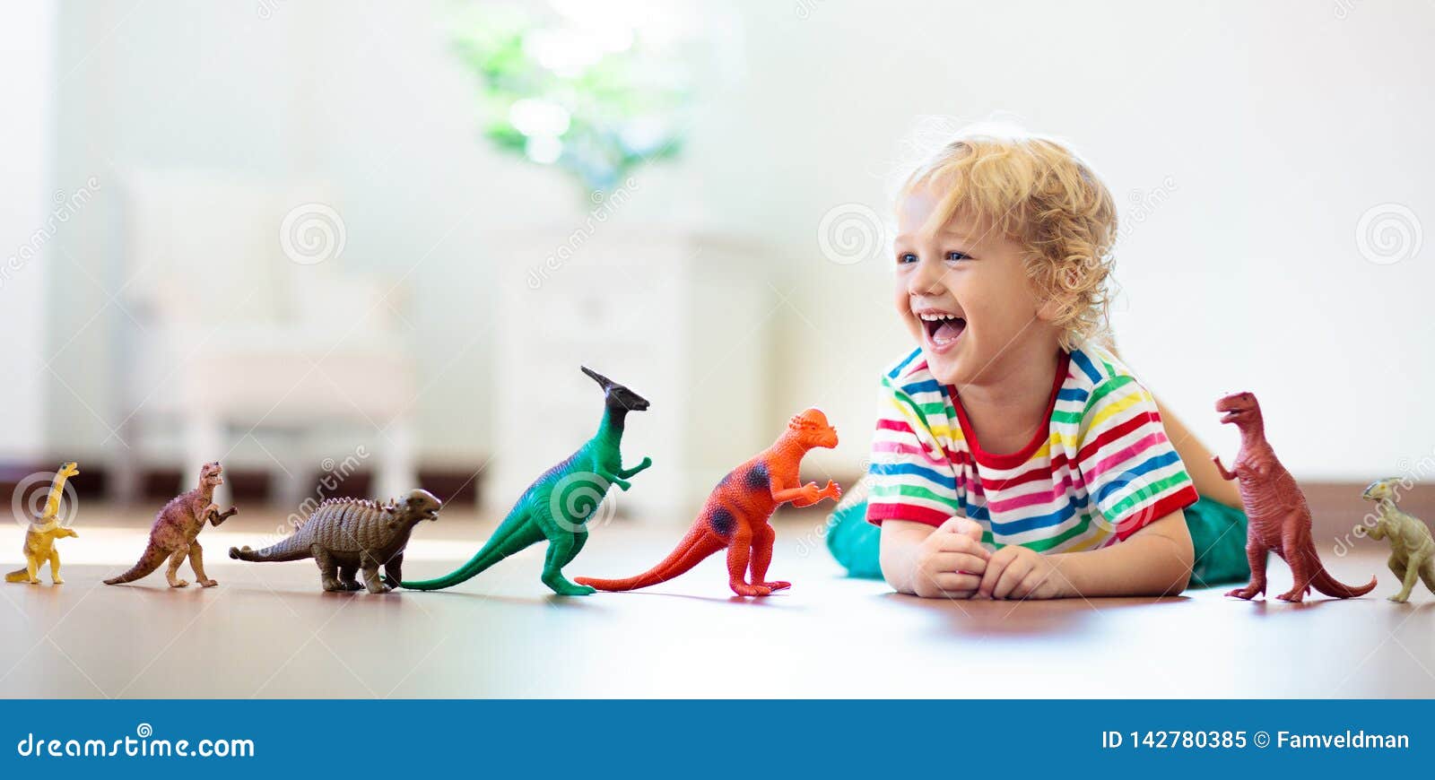 child playing with toy dinosaurs. kids toys