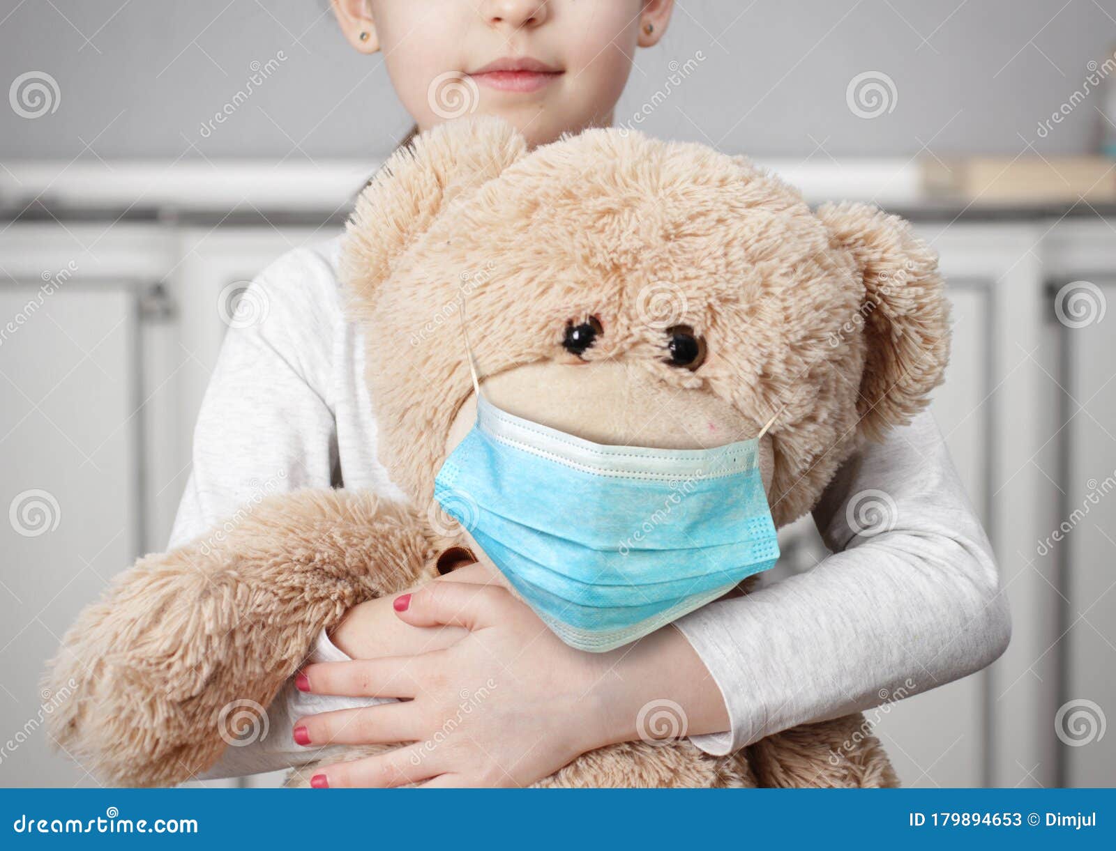 child on quarantine due epidemic of coronavirus covid-19. child girl cuddle toy bear wear medical mask