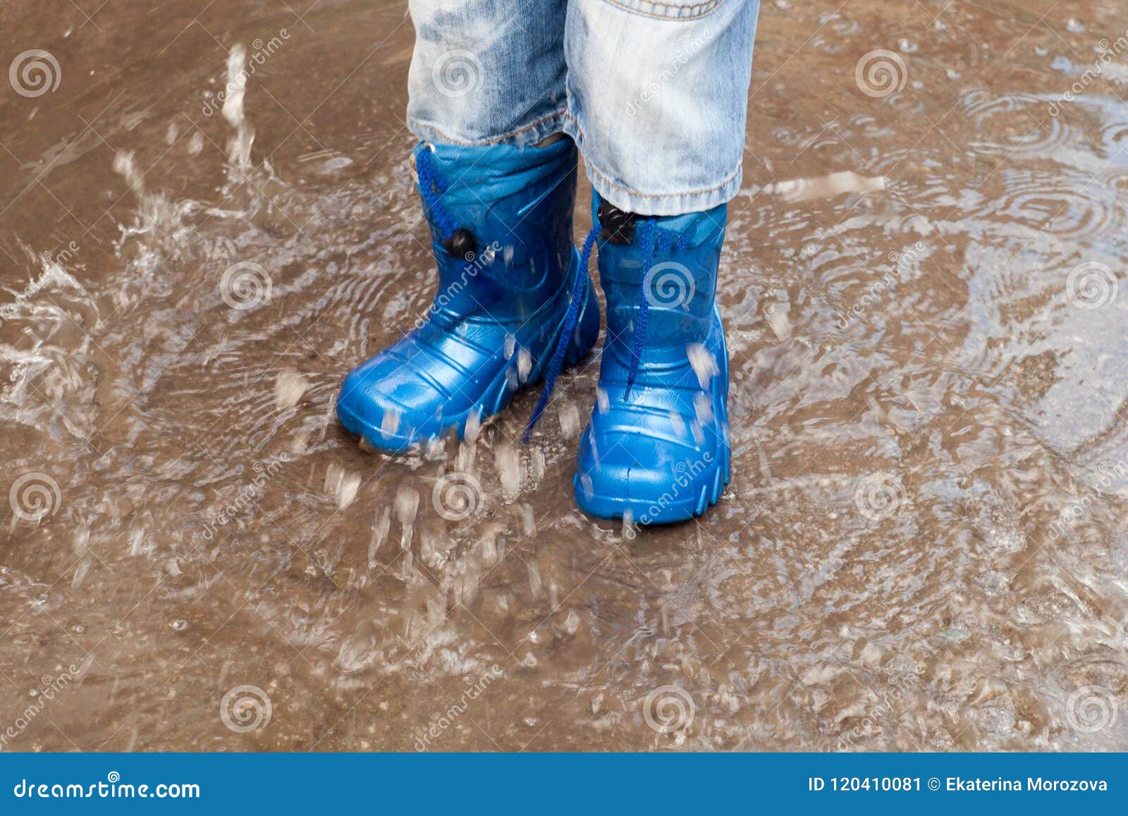 Child with Rain Boots Jumps into a Puddle. Stock Image - Image of ...