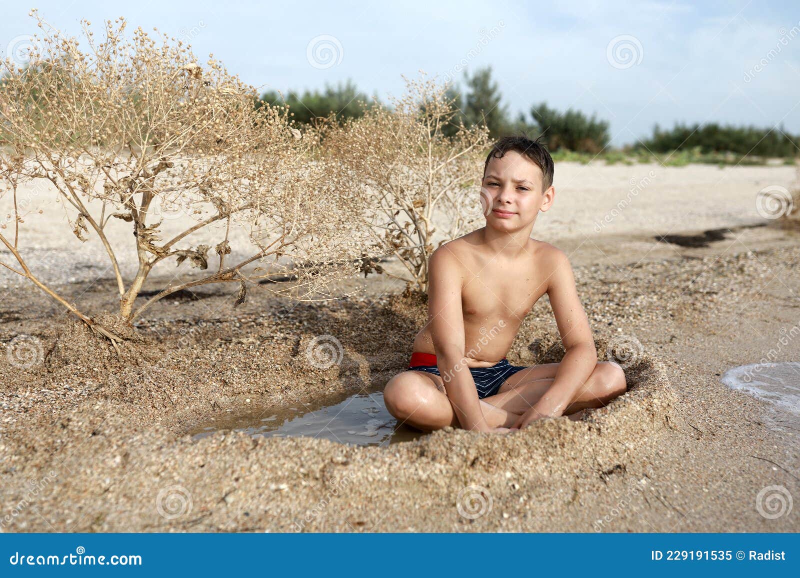 child resting on beach of azov sea