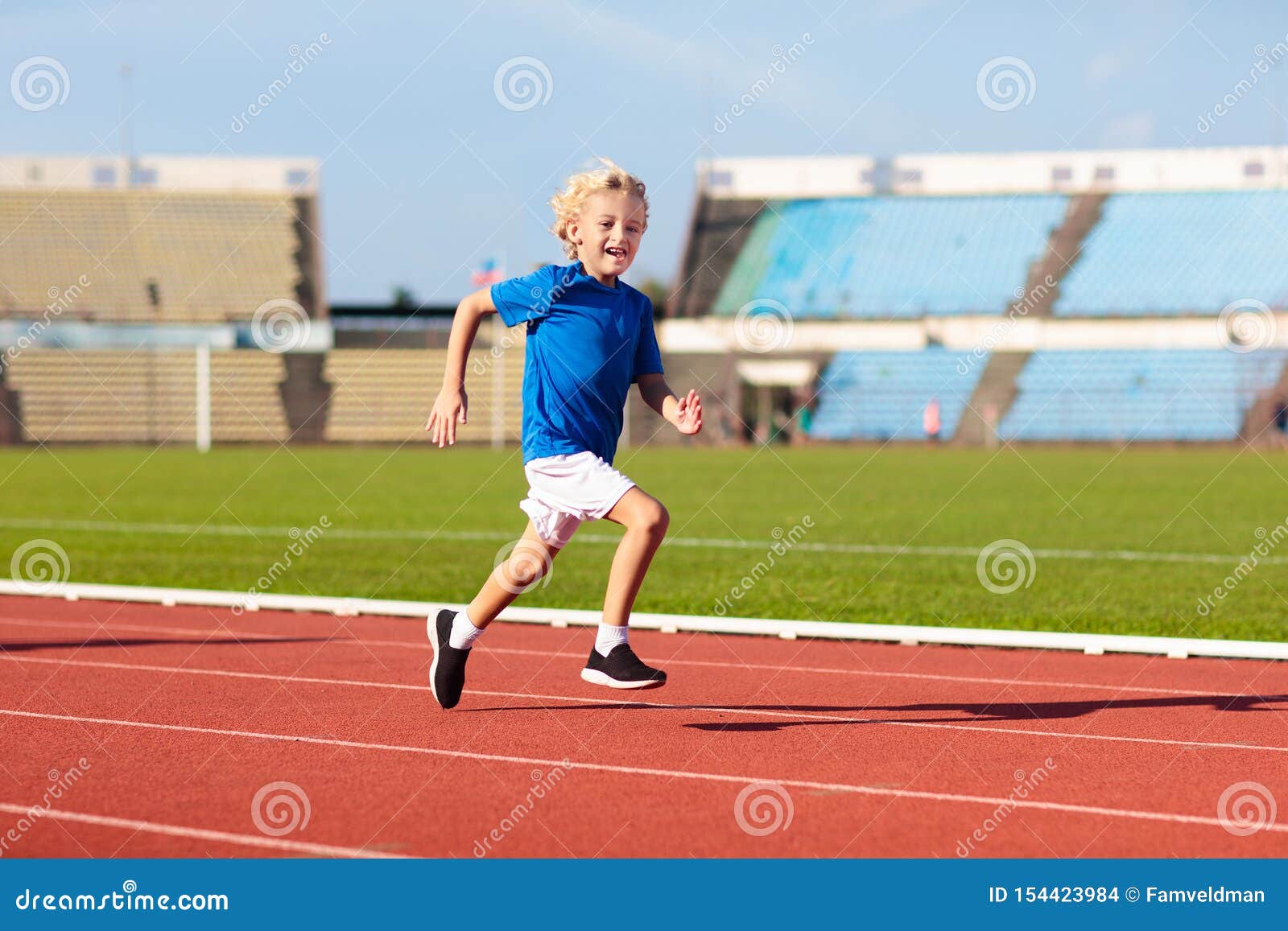 child running in stadium. kids run. healthy sport