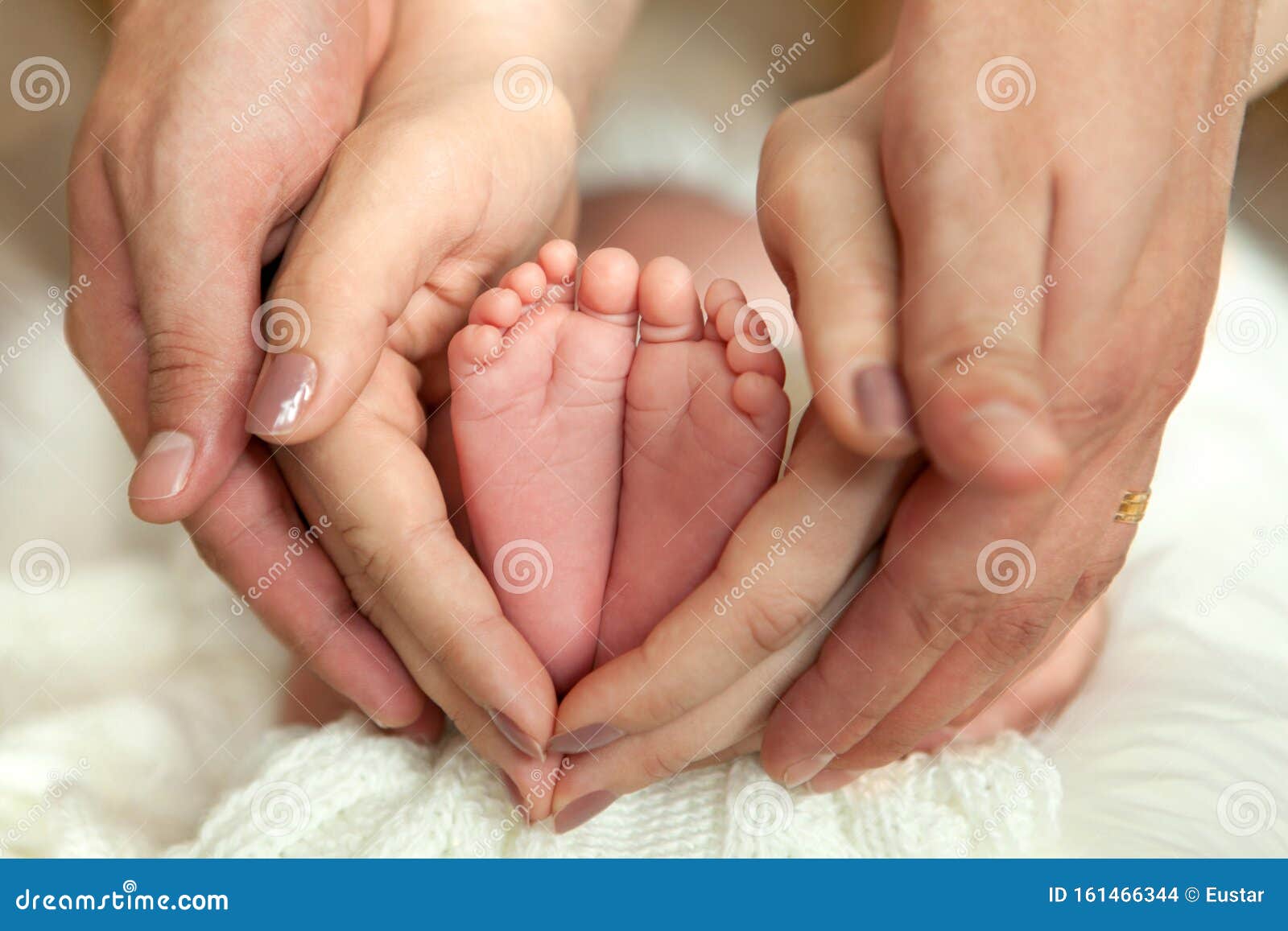 Child`s Foot in Mother and Father`s Hands. Pure Love. Stock Photo ...
